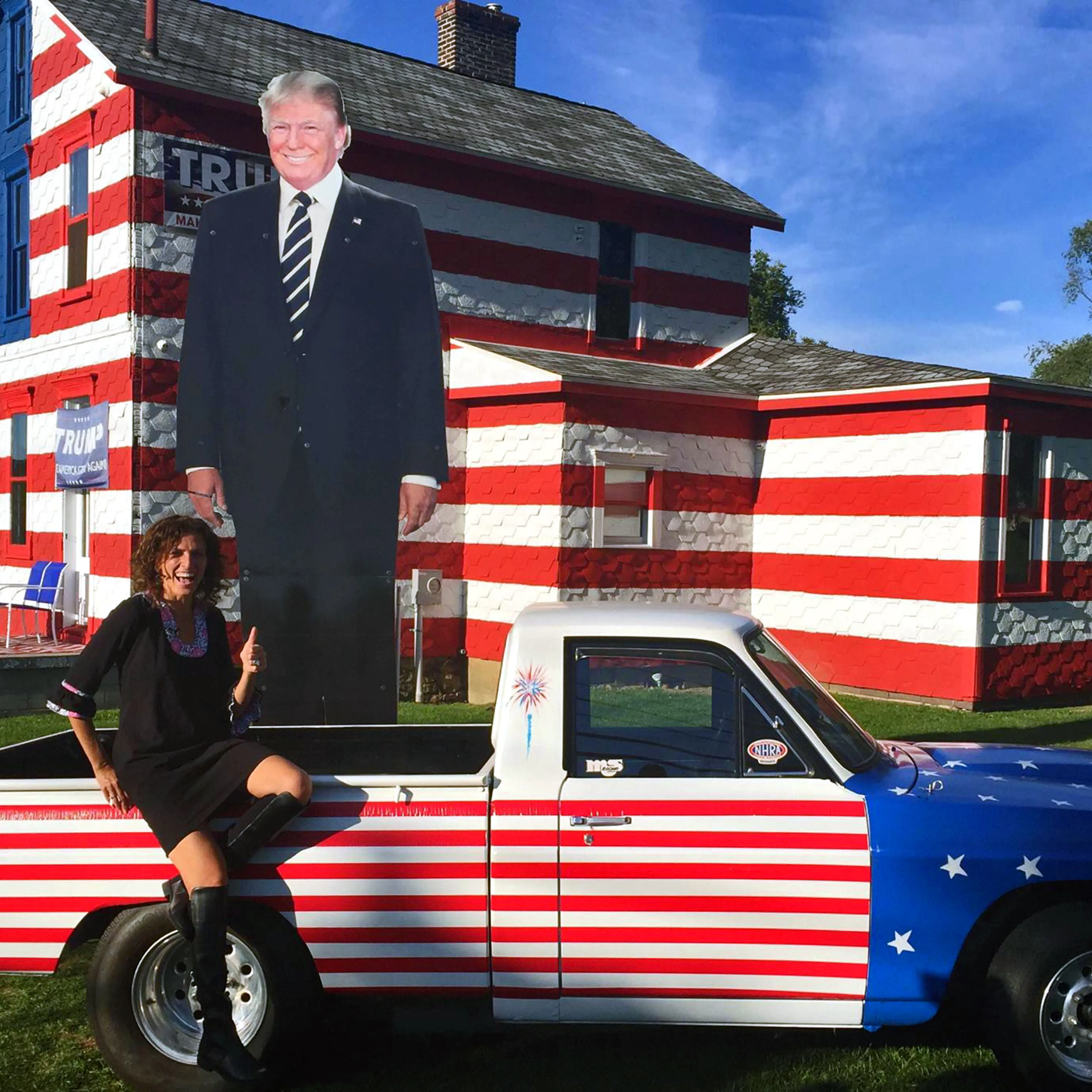 Leslie Rossi sits outside of her "Trump House" in Latrobe, Pennsylvania. She said thousands of people check out the house every week.