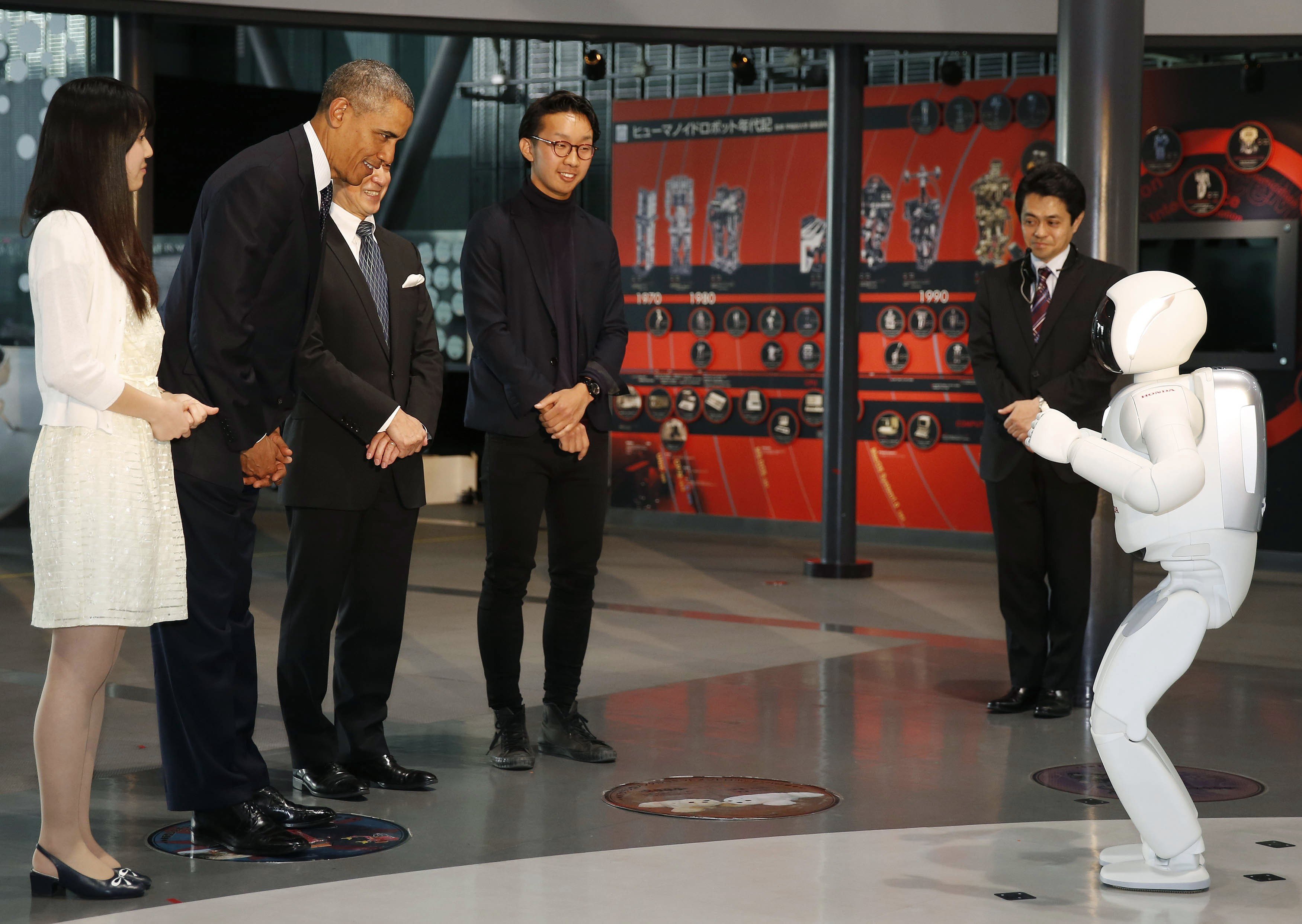 U.S. President Barack Obama bows to "Asimo" the robot while visiting Miraikan or the National Museum of Emerging Science and Innovation, in Tokyo, April 24, 2014.