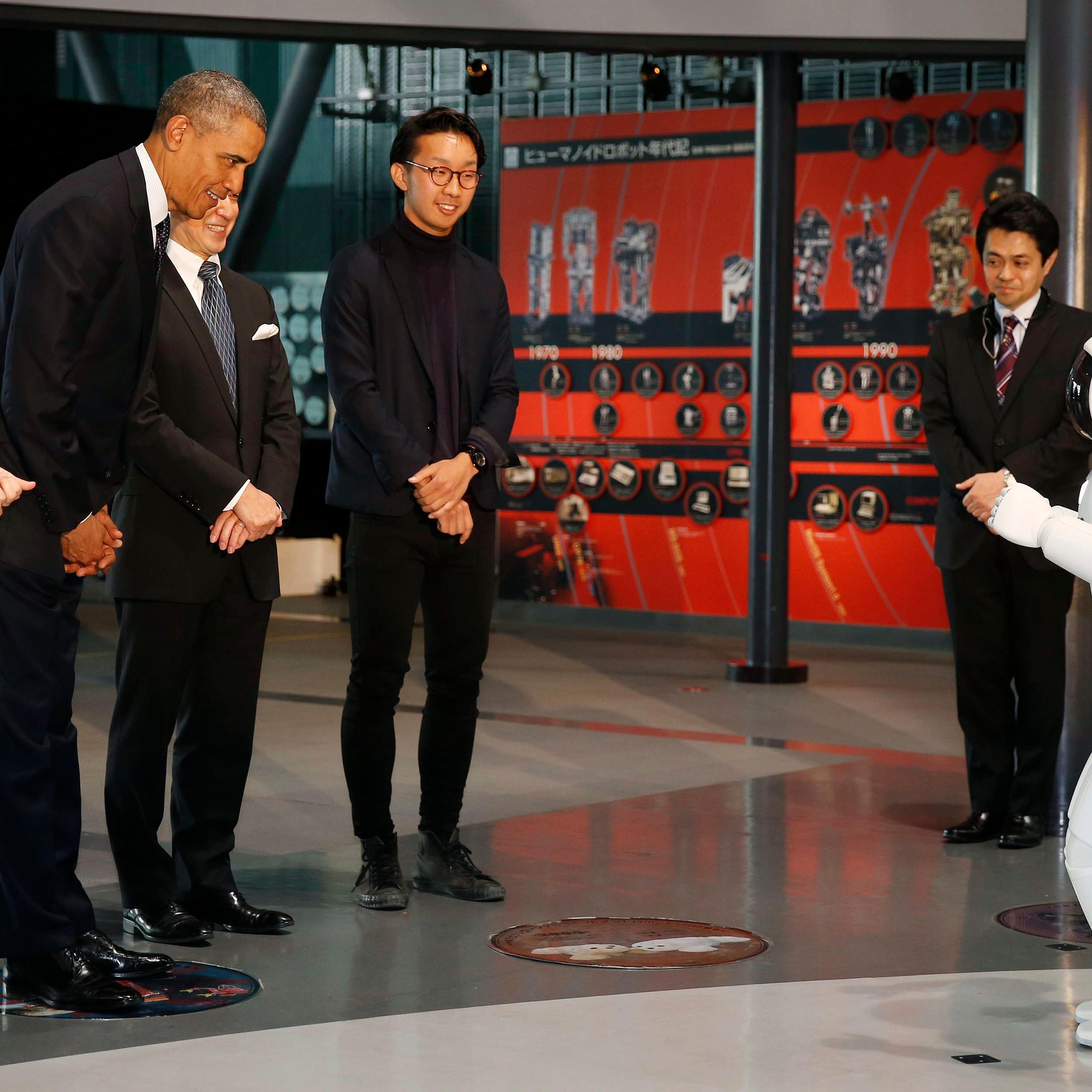 U.S. President Barack Obama bows to "Asimo" the robot while visiting Miraikan or the National Museum of Emerging Science and Innovation, in Tokyo, April 24, 2014.