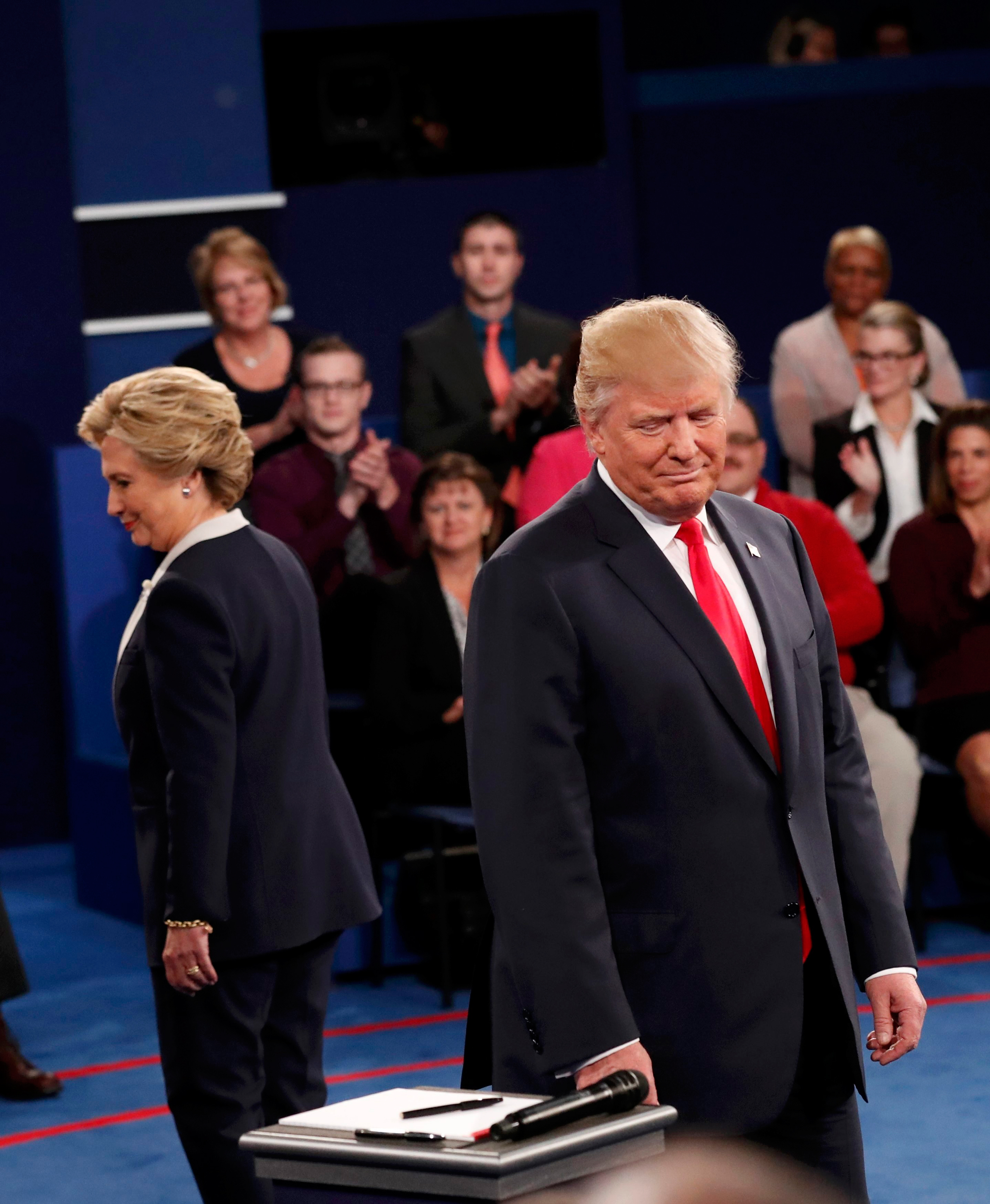 Republican U.S. presidential nominee Donald Trump and Democratic U.S. presidential nominee Hillary Clinton take the stage at the start of their presidential town hall debate at Washington University in St. Louis, Missouri, U.S., October 9, 2016. REUTERS/