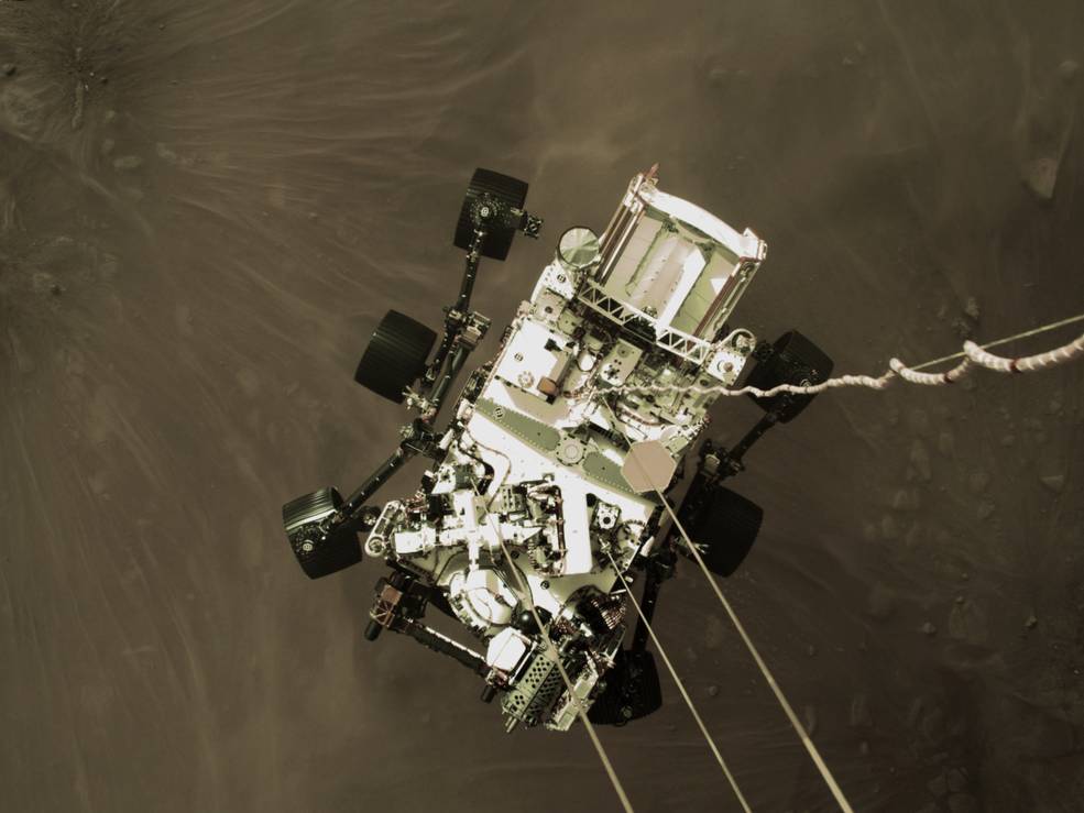 The Perseverance rover is lowered to the surface of Mars on Feb. 18 in image captured by the spacecraft's descent stage.