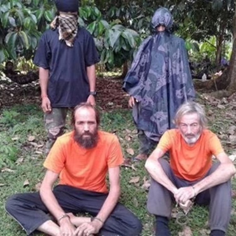 Hostages Canadian national Robert Hall and Norwegian national Kjartan Sekkingstad are seen in this undated picture released to local media, in Jolo