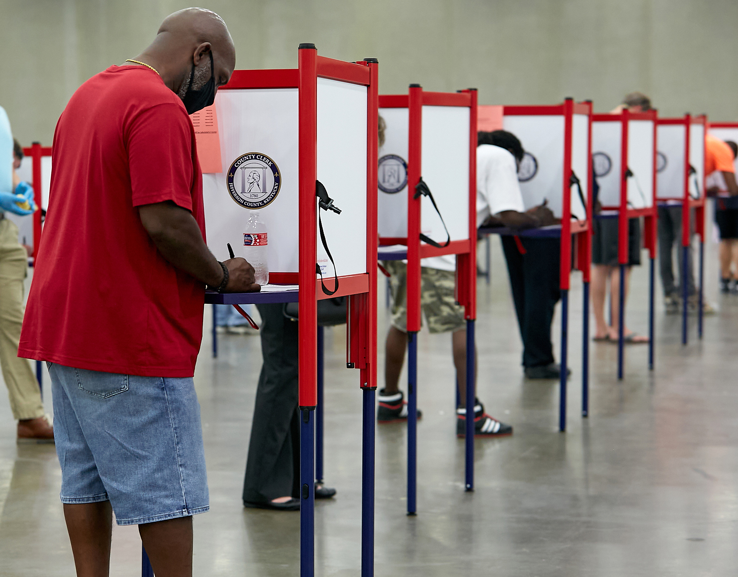 Primary voters cast their ballots at a polling place in Louisville, Ky., on June 23