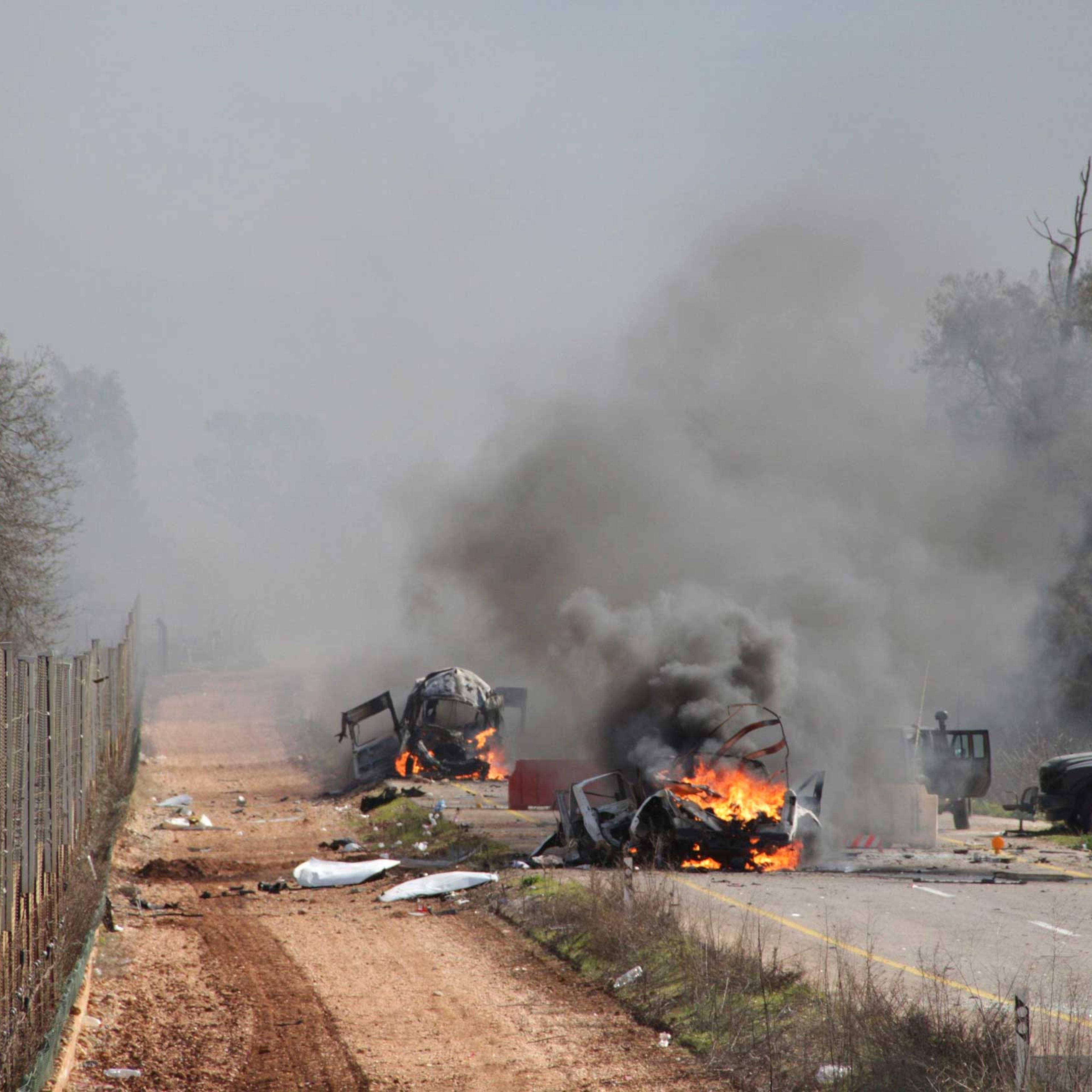 Burning vehicles are seen near the village of Ghajar on Israel's border with Lebanon, Jan. 28, 2015.