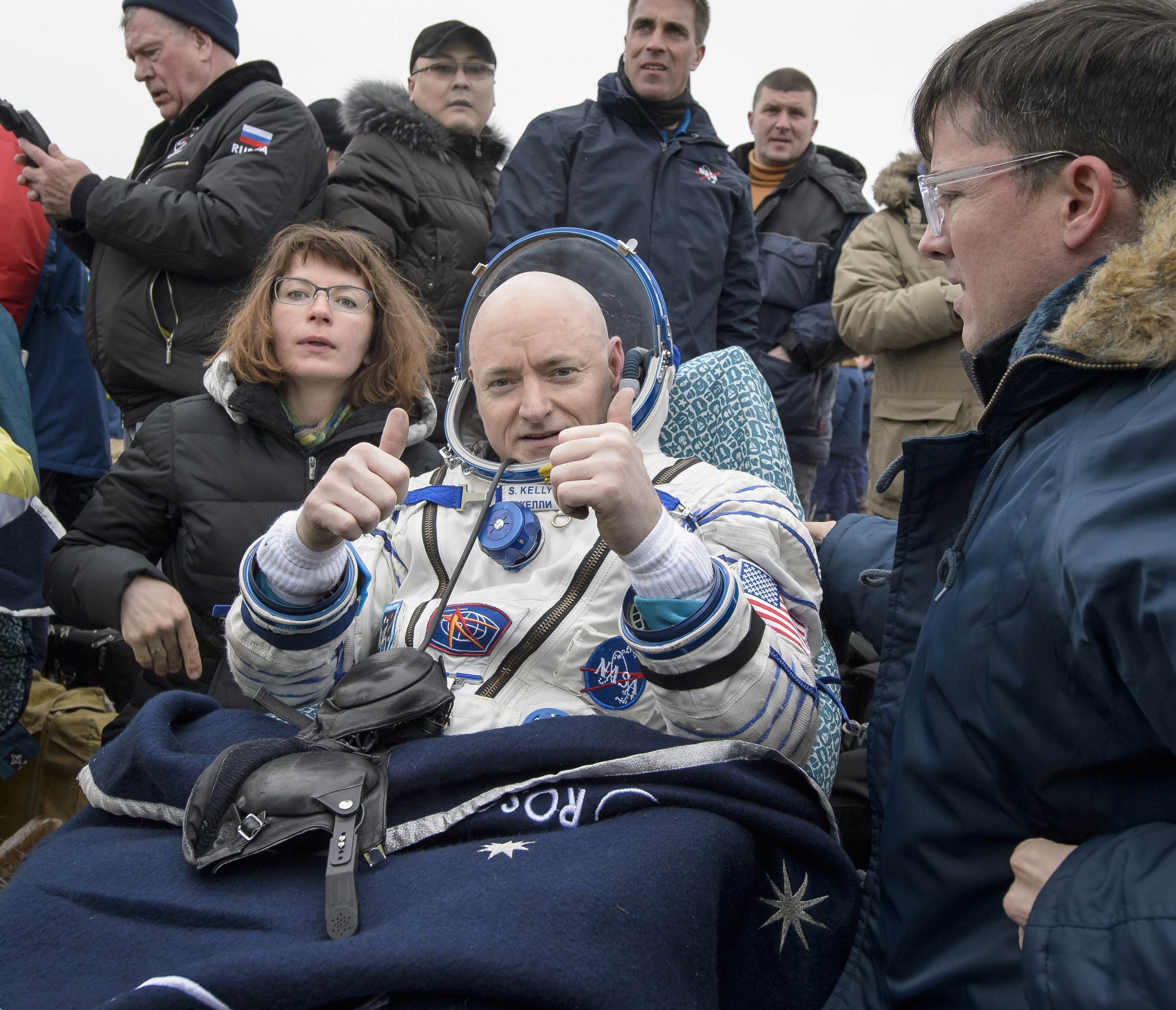 Expedition 46 Commander Scott Kelly of NASA rest in a chair outside of the Soyuz TMA-18M spacecraft near the town of Zhezkazgan Kazakhstan