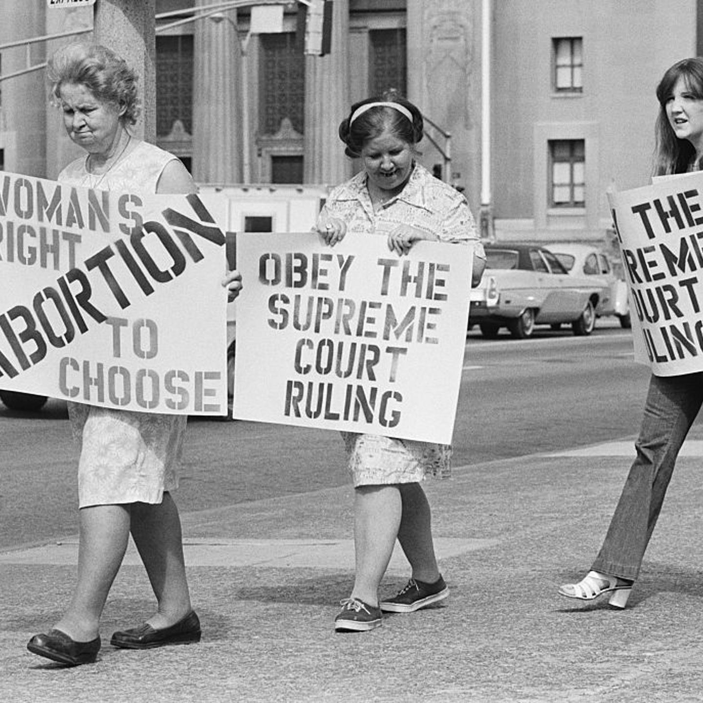 Three generations apart but together on their stand on abortion, Adelle Thomas, 67 (L), her daughter, Marie Higgins, 47 (center), and her daughter, Catherine Starr, 17 (R), join in the picket line here May, 24, 1973, which marched around City Hall.