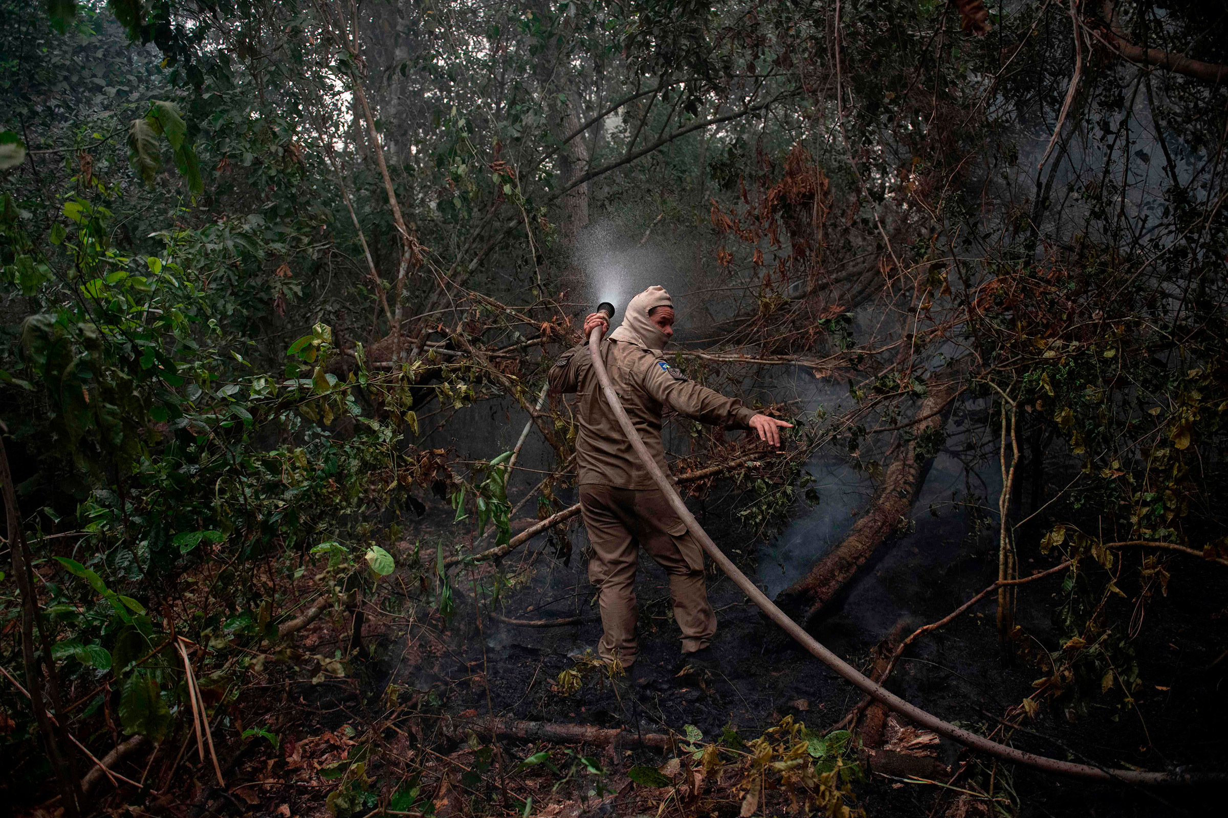 Firefighters work to put out a wildfire in the Porto Jofre region on Sept. 14.
