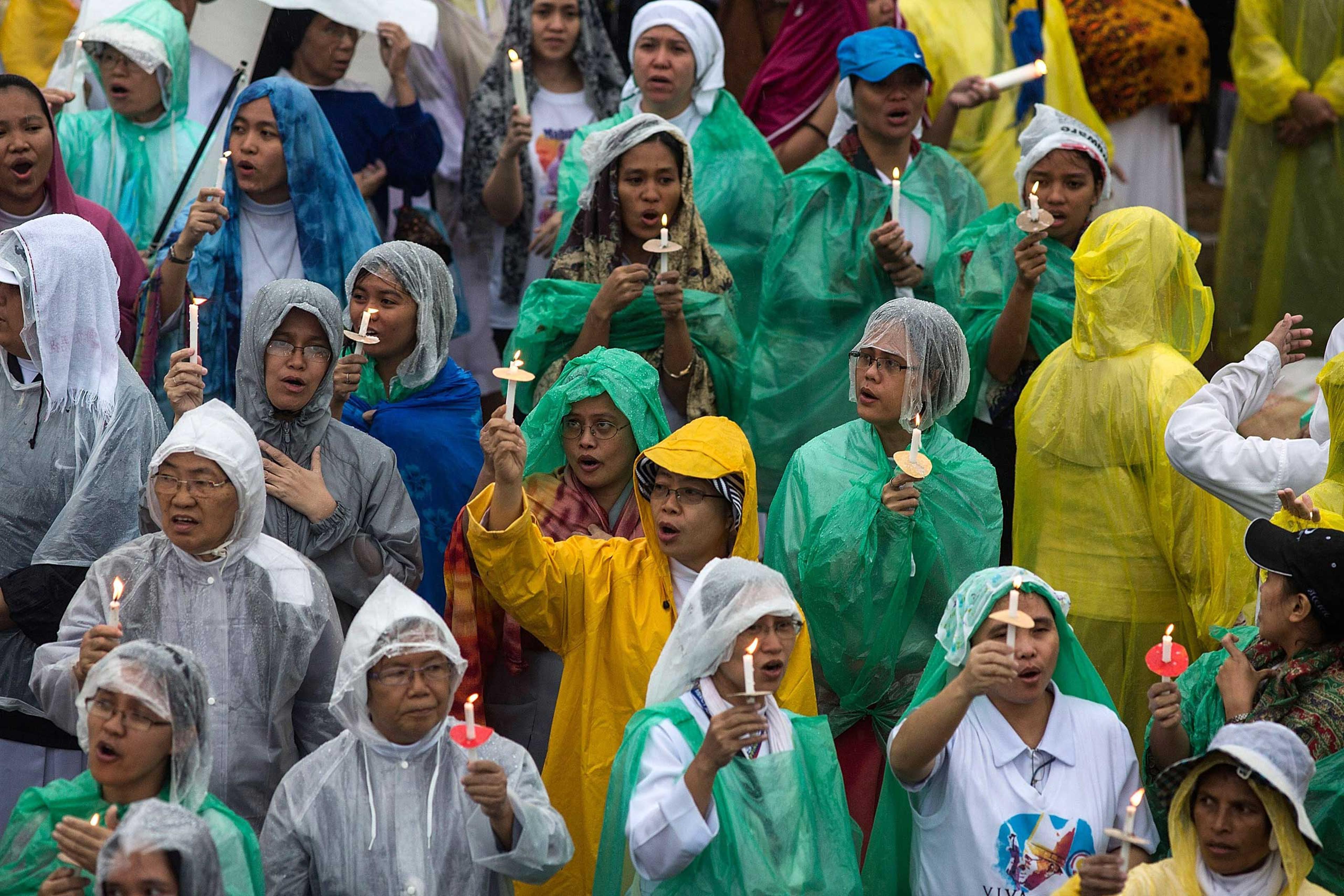 Pilgrims pray as Pope Francis conducts mass at the Rizal Park on Jan. 18, 2015 in Manila.