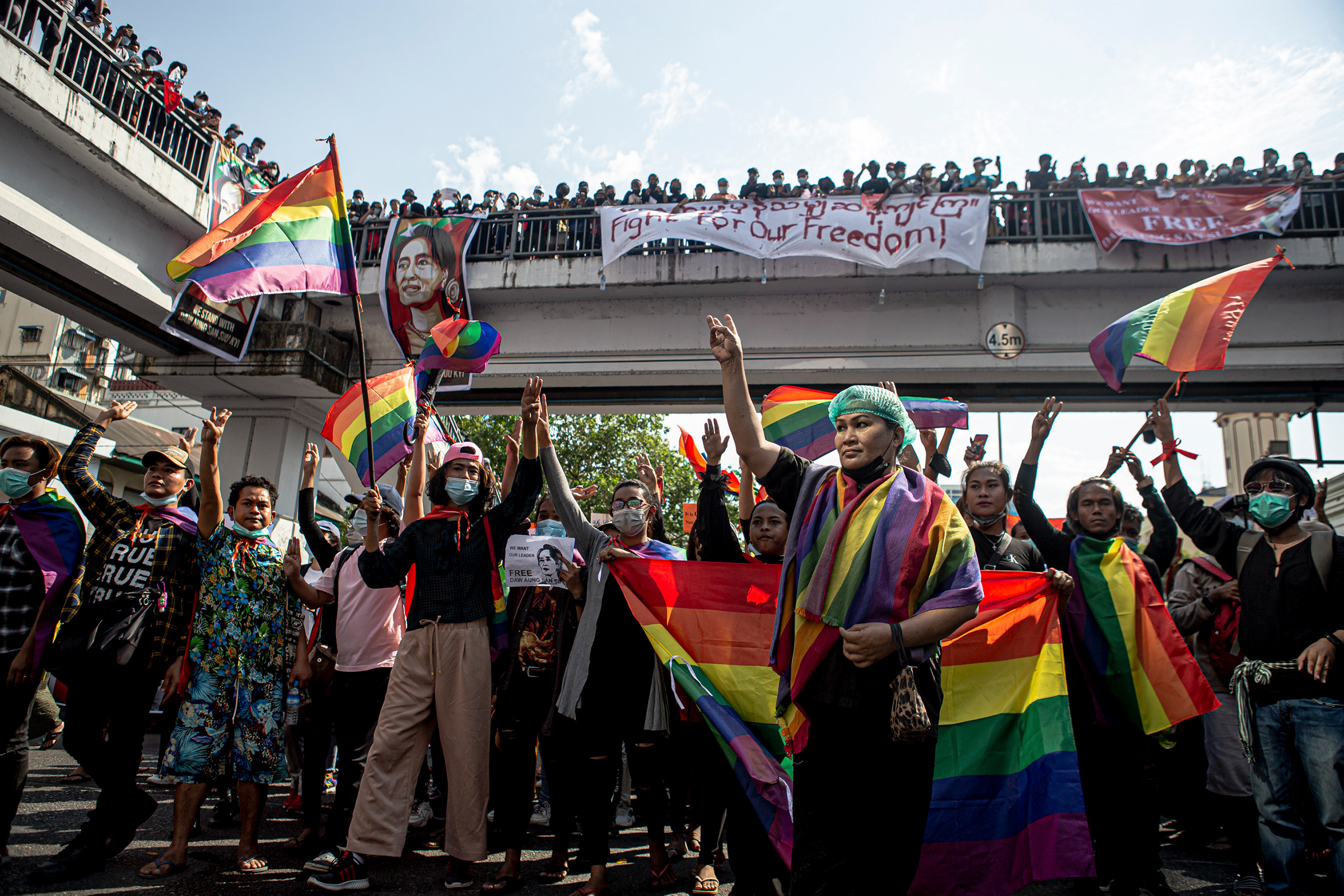 Members of LGBTQ community flash pride flags and take part in protests against the military coup on Feb. 8 in Yangon, Myanmar.