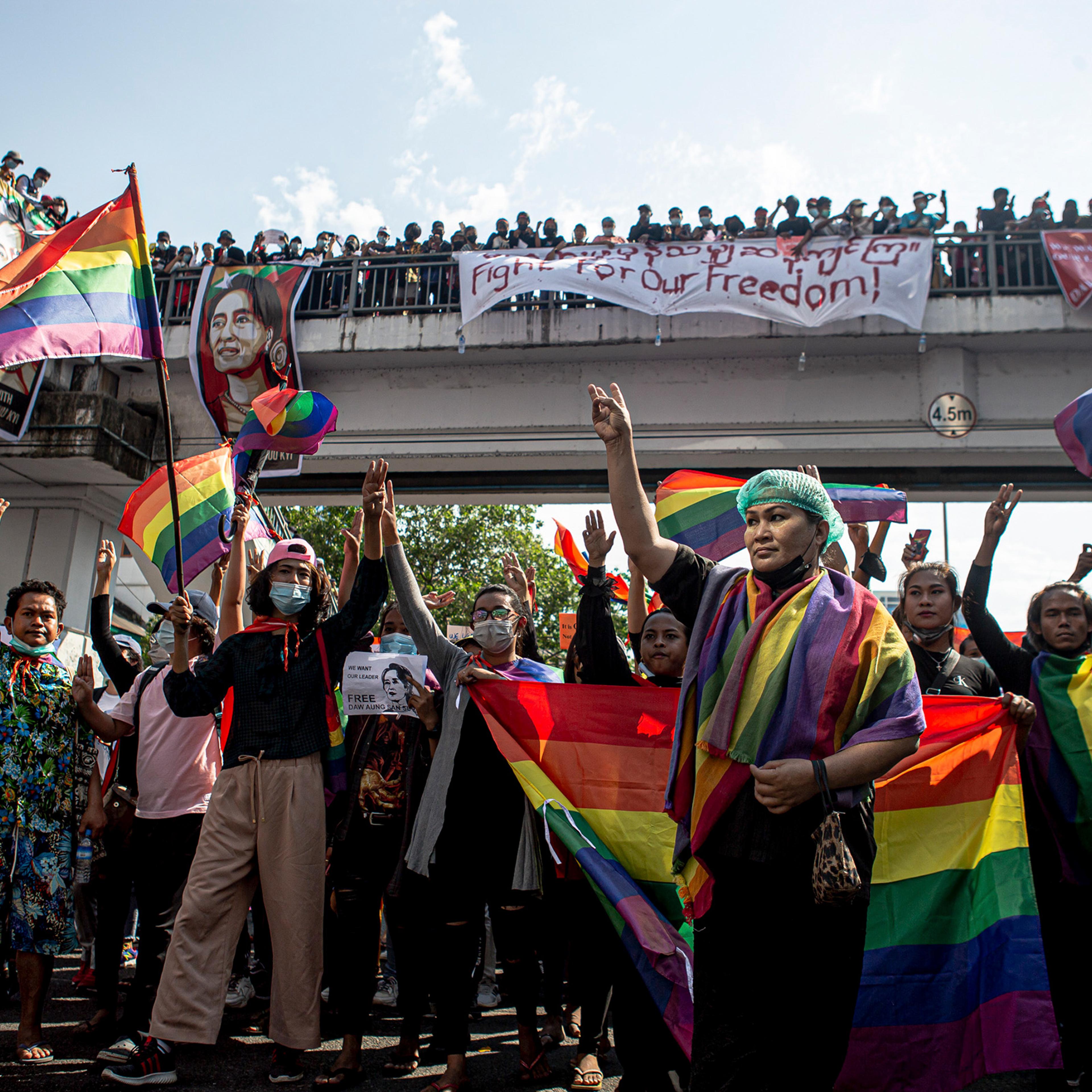 Members of LGBTQ community flash pride flags and take part in protests against the military coup on Feb. 8 in Yangon, Myanmar.