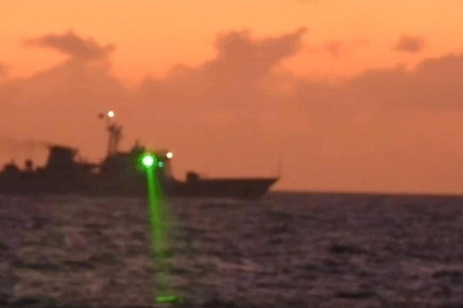 A photo provided by the Philippine Coast Guard appears to show the alleged 'military-grade' laser light shining from a Chinese ship in the South China Sea on Feb. 6, 2023.