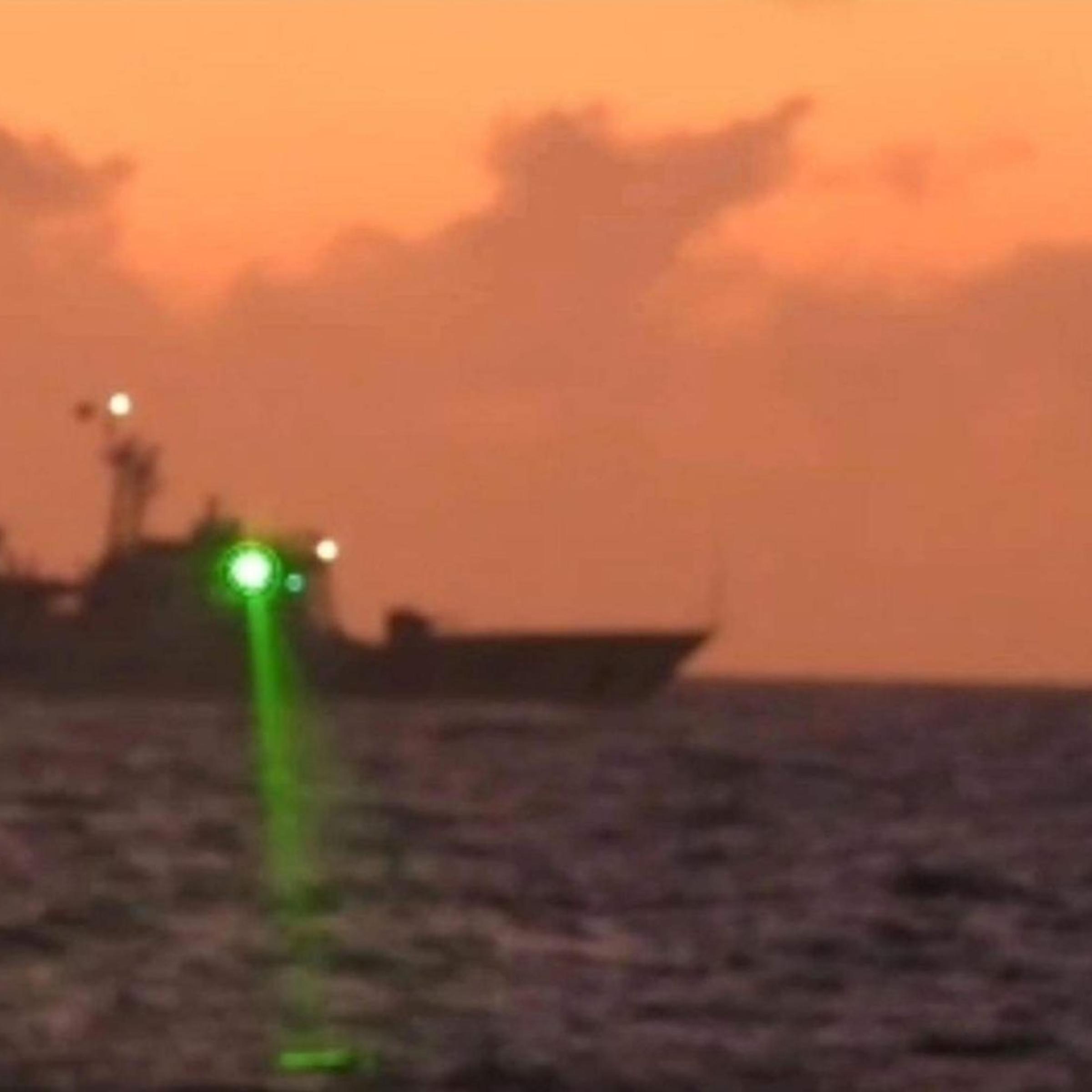 A photo provided by the Philippine Coast Guard appears to show the alleged 'military-grade' laser light shining from a Chinese ship in the South China Sea on Feb. 6, 2023.