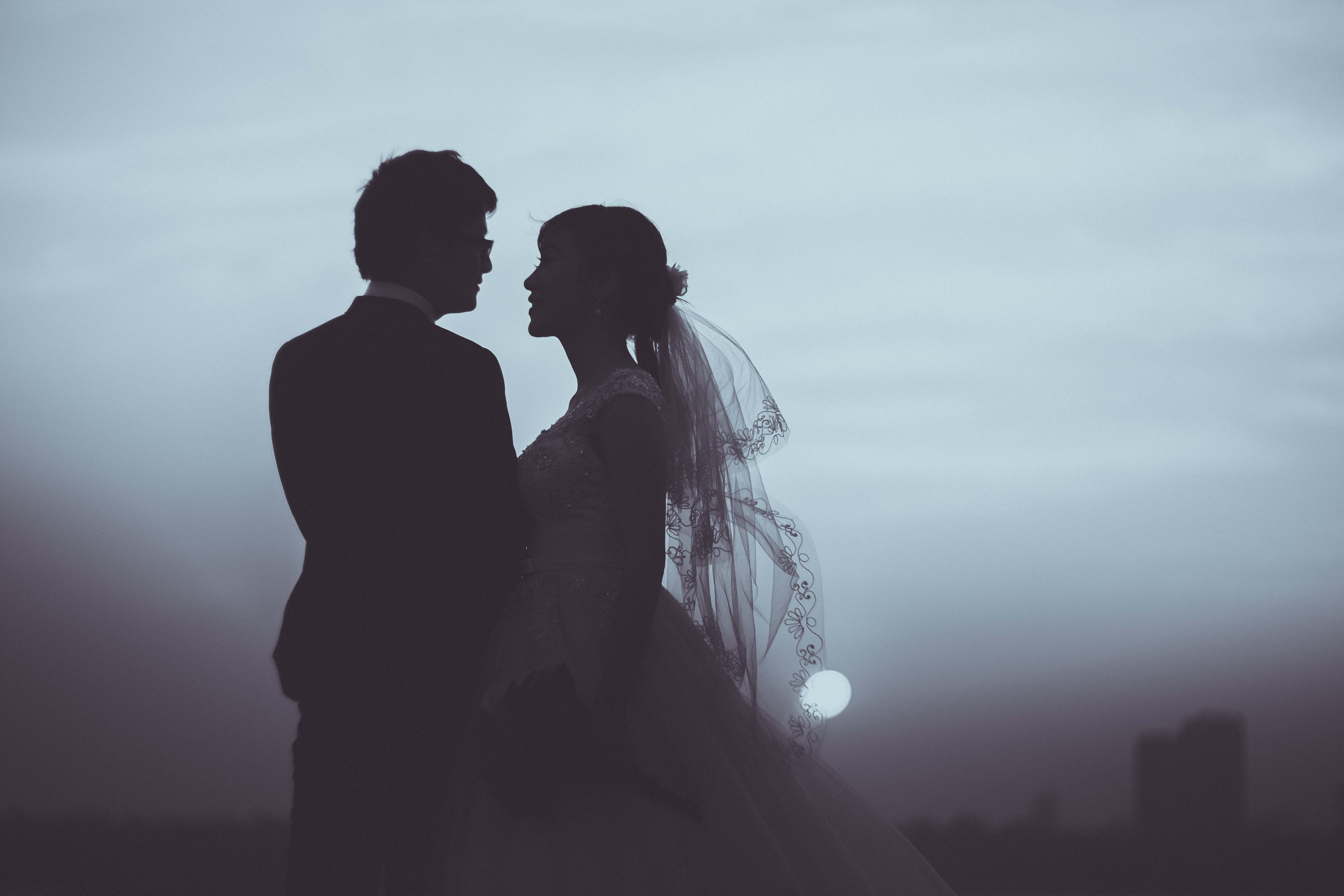 Silhouette of bride and groom wedding at sunset
