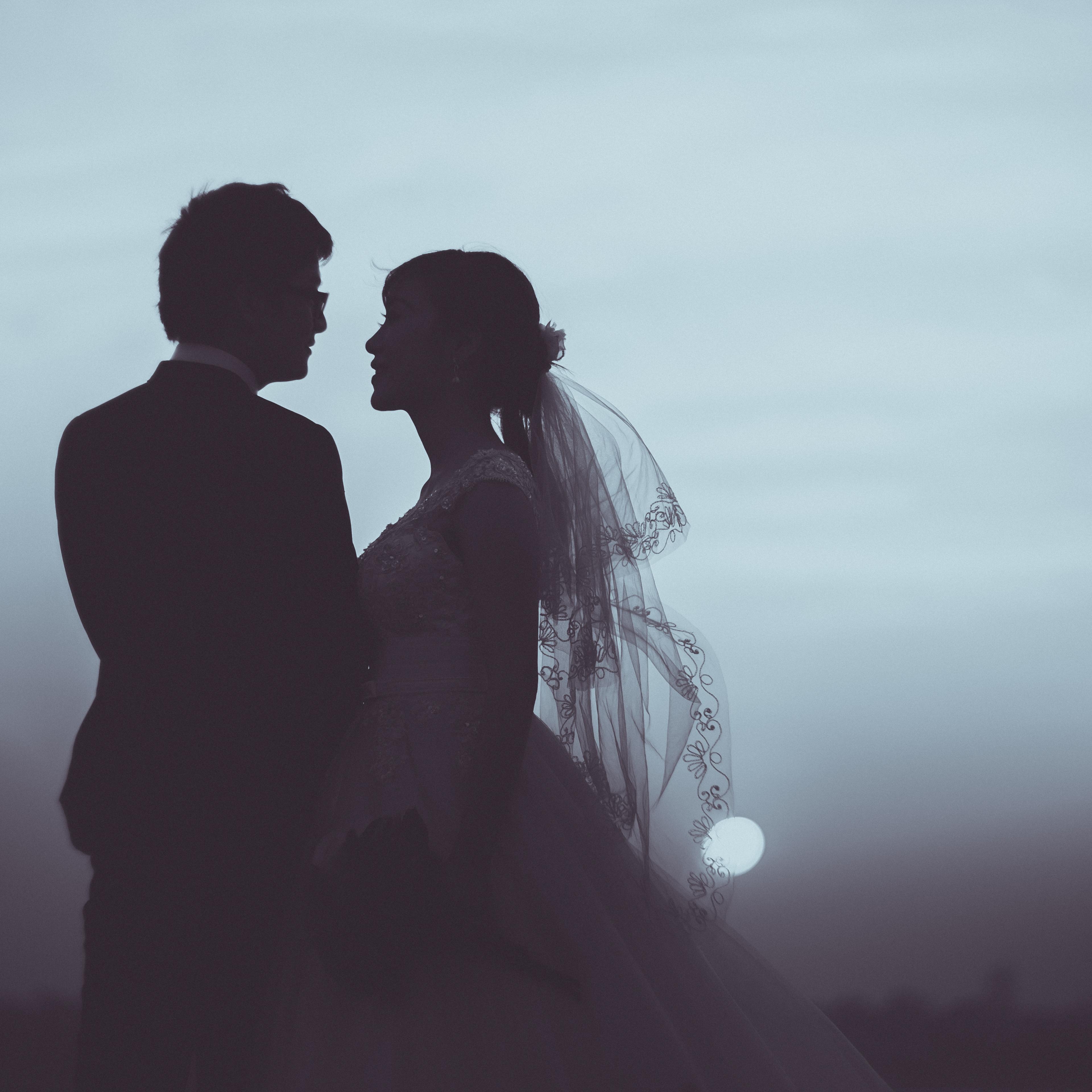 Silhouette of bride and groom wedding at sunset