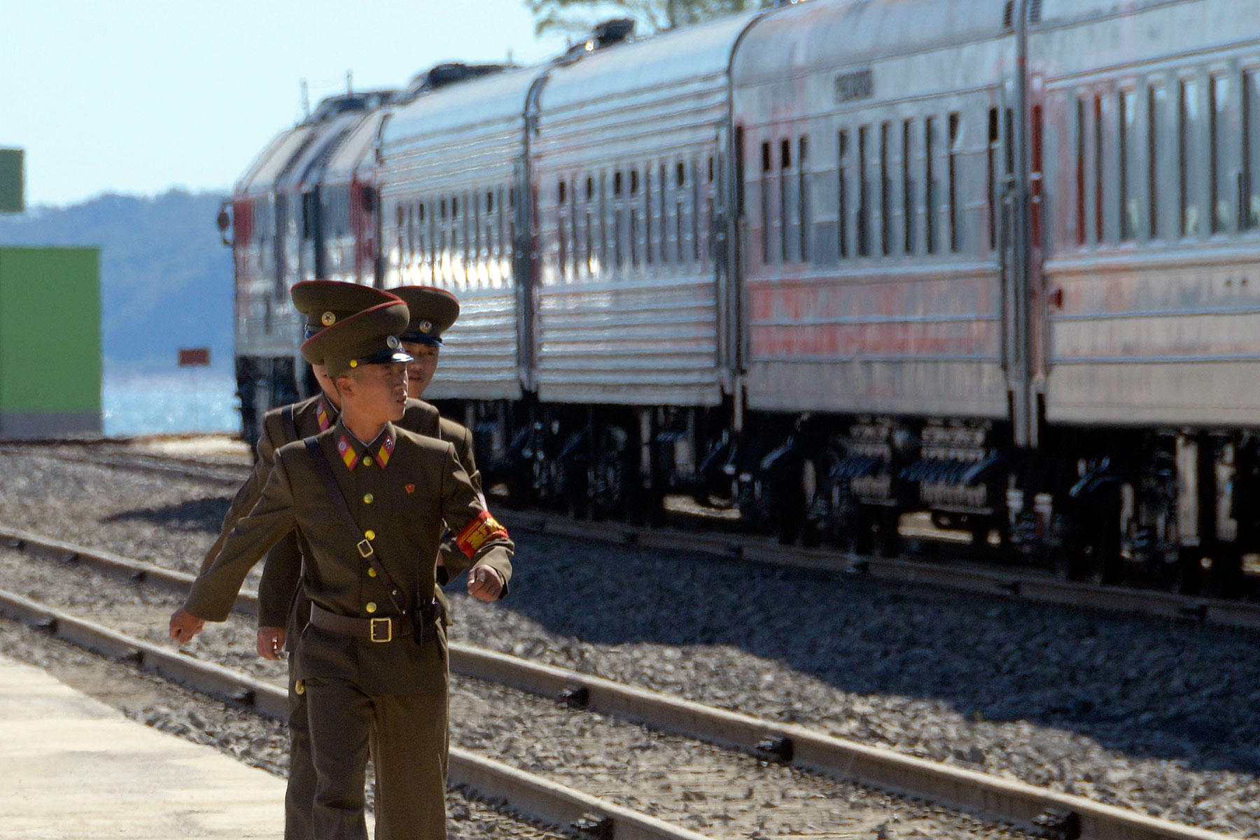 North Korean soldiers march near trains after a ceremony to mark the re-opening of a railway link between Russia and North Korea at the port of Rajin Sept. 22, 2013