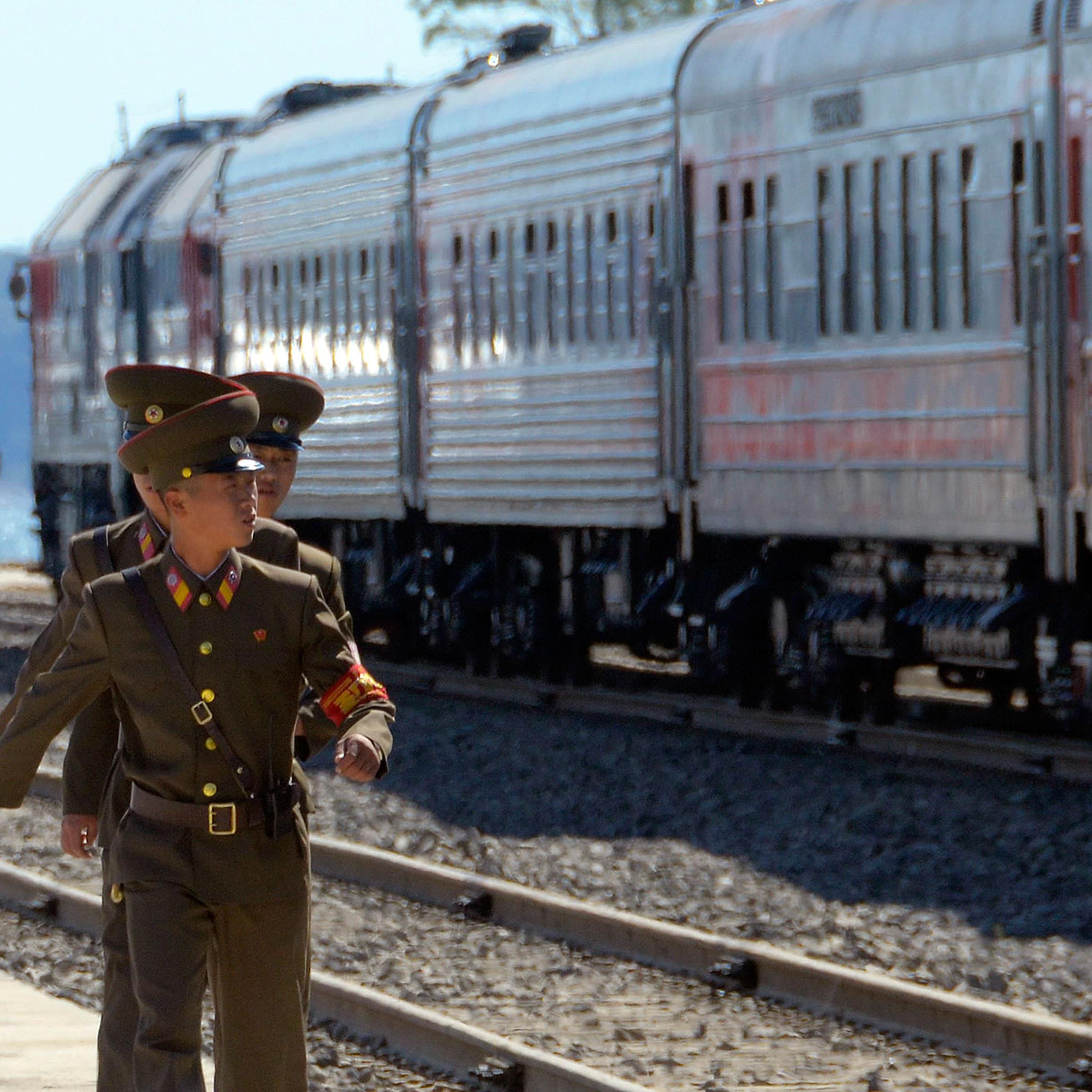 North Korean soldiers march near trains after a ceremony to mark the re-opening of a railway link between Russia and North Korea at the port of Rajin Sept. 22, 2013
