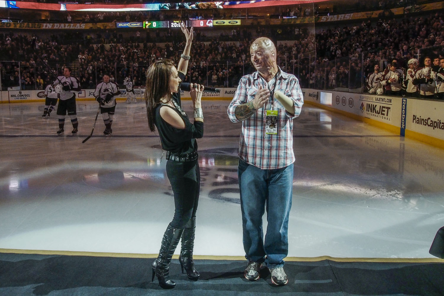 2013.  Dallas, TX.  USA.  Bobby on ice with singer Celine Ray after the national anthem.  He was the center of Military Appreciation night for the Dallas Stars NHL team.  Bobby Henline, 41, veteran of four tours to Iraq and sole survivor of an IED blast 