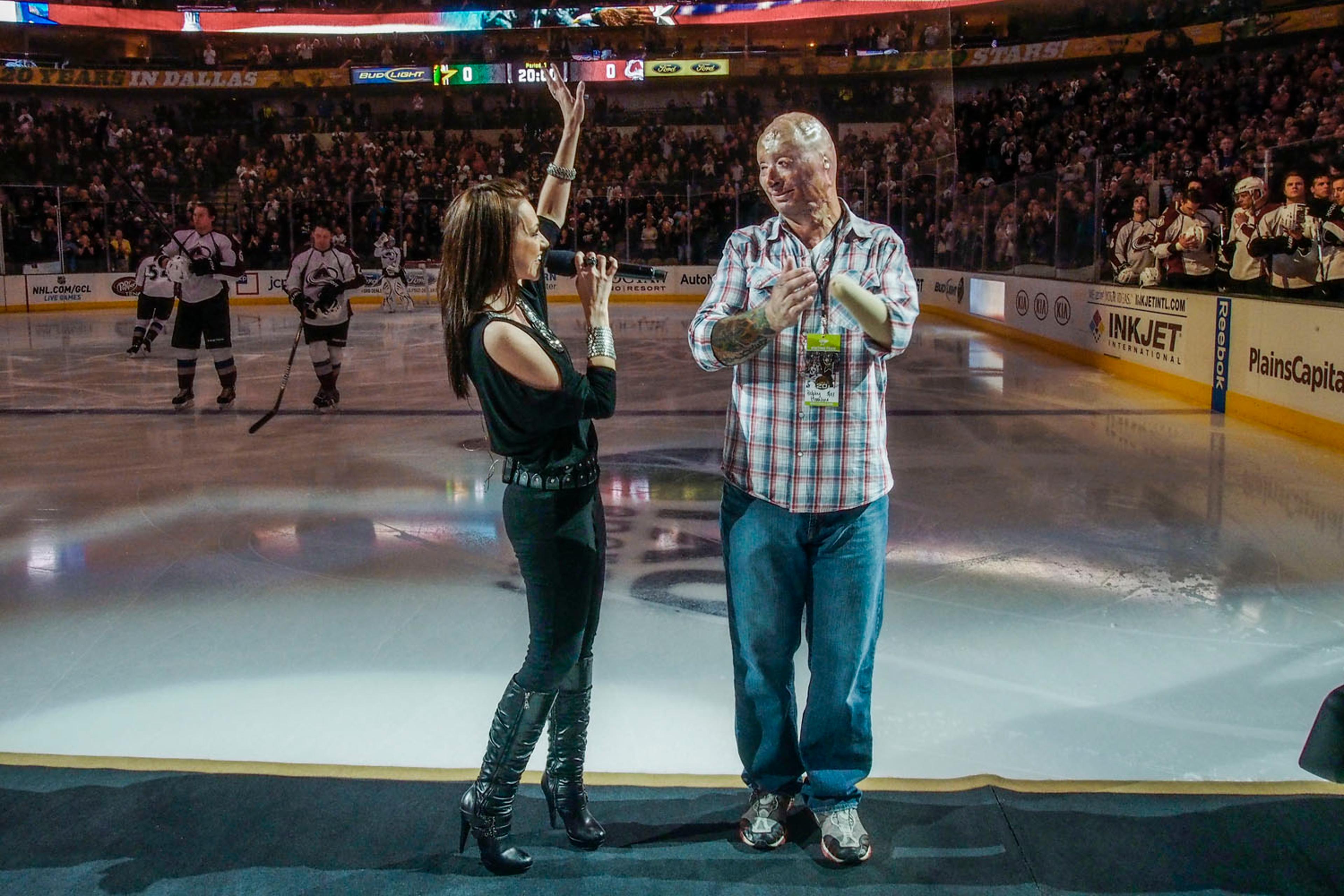 2013. Dallas, TX. USA. Bobby on ice with singer Celine Ray after the national anthem. He was the center of Military Appreciation night for the Dallas Stars NHL team. Bobby Henline, 41, veteran of four tours to Iraq and sole survivor of an IED blast