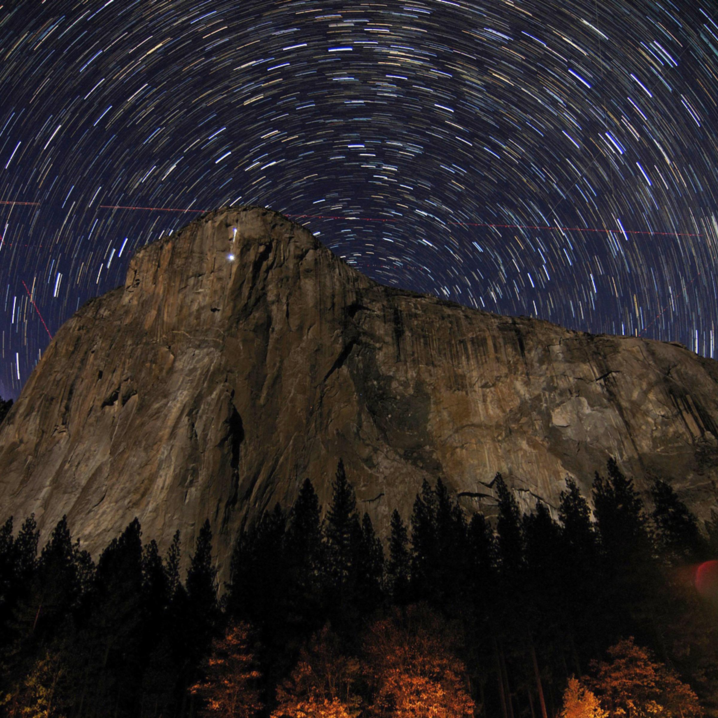 Star trails are visible over the granite face of El Capitan in Earth's Yosemite National Park in this image taken on November 8, 2013 and in March 2014.