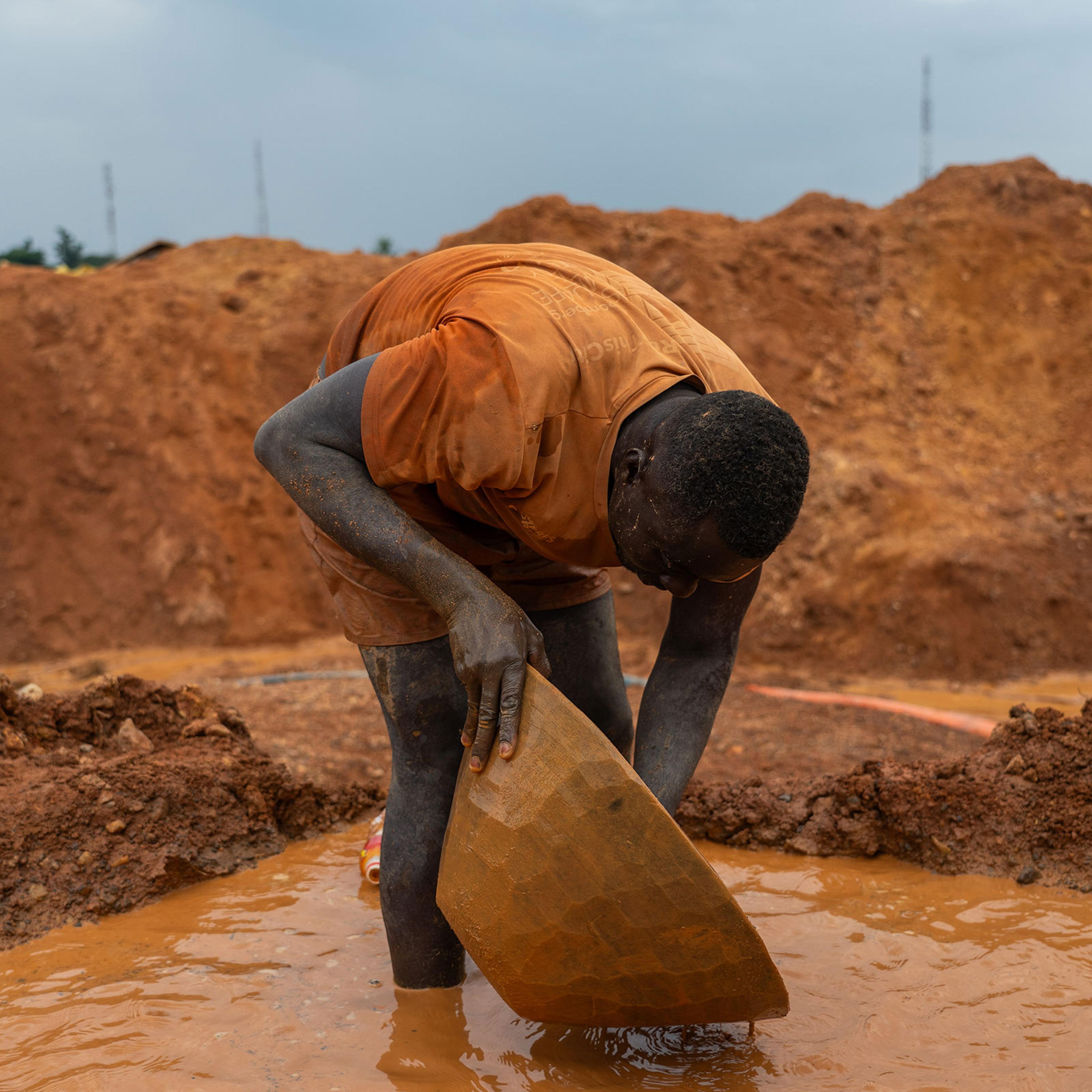 A miner searches for gold at a mine outside Kumasi.