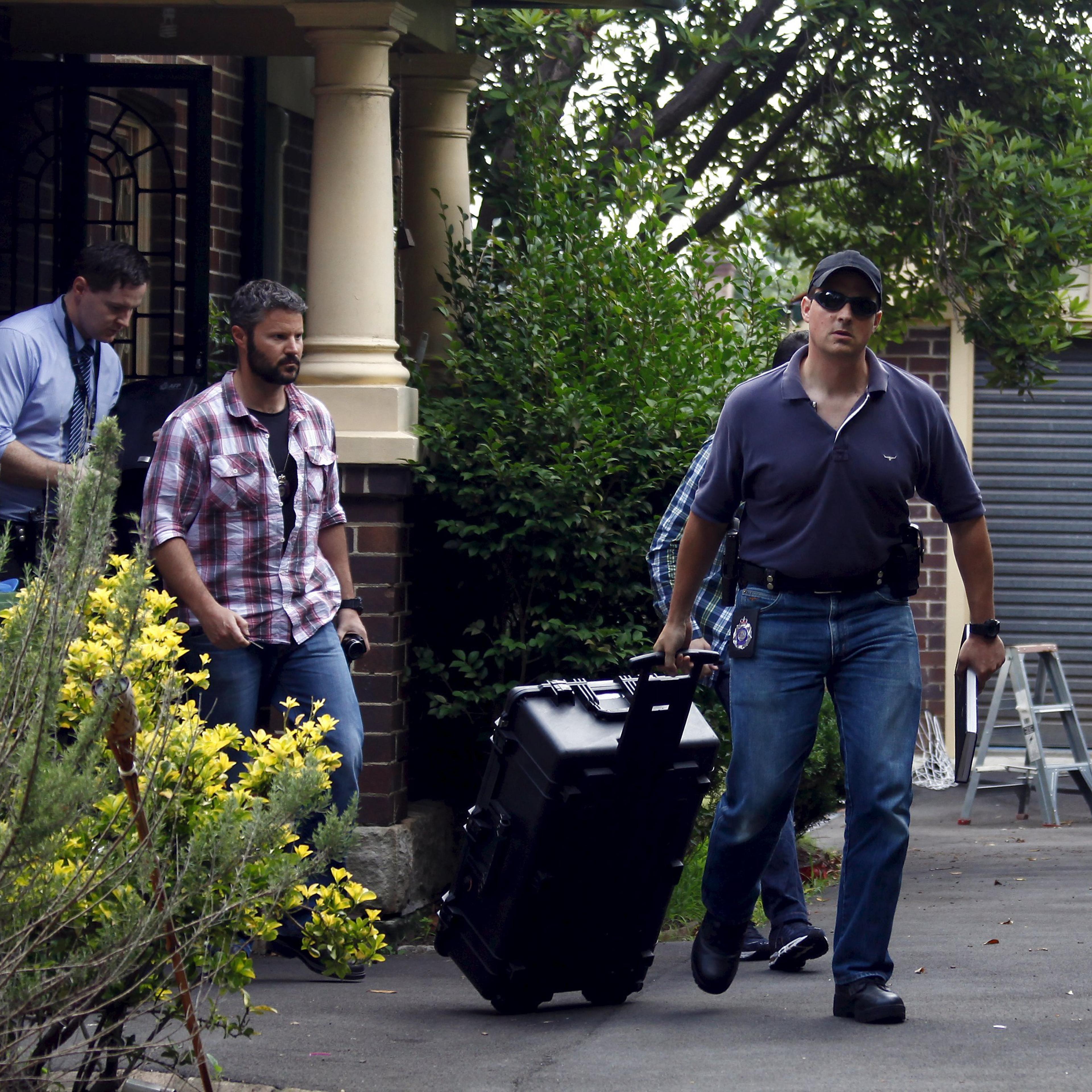 Australian Federal Police officers walk down the driveway after searching the home of probable creator of cryptocurrency bitcoin Craig Steven Wright in Sydney's north shore December 9, 2015.