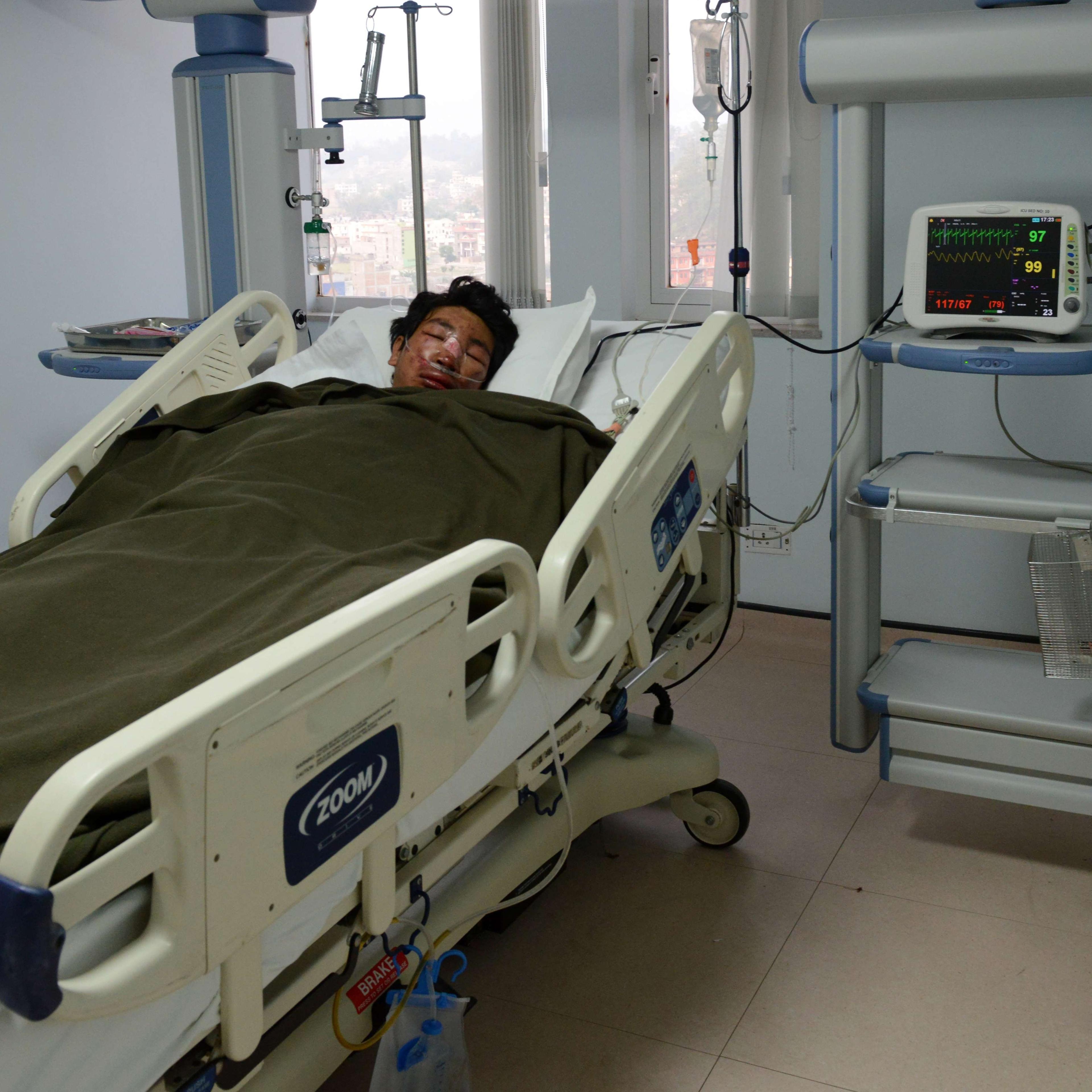 Nepalese mountaineer, Dawa Tashi Sherpa, survivor of the avalanche on Mount Everest, lies in the Intensive Care Unit (ICU) at Grandi International Hospital in Kathmandu on April 18, 2014.