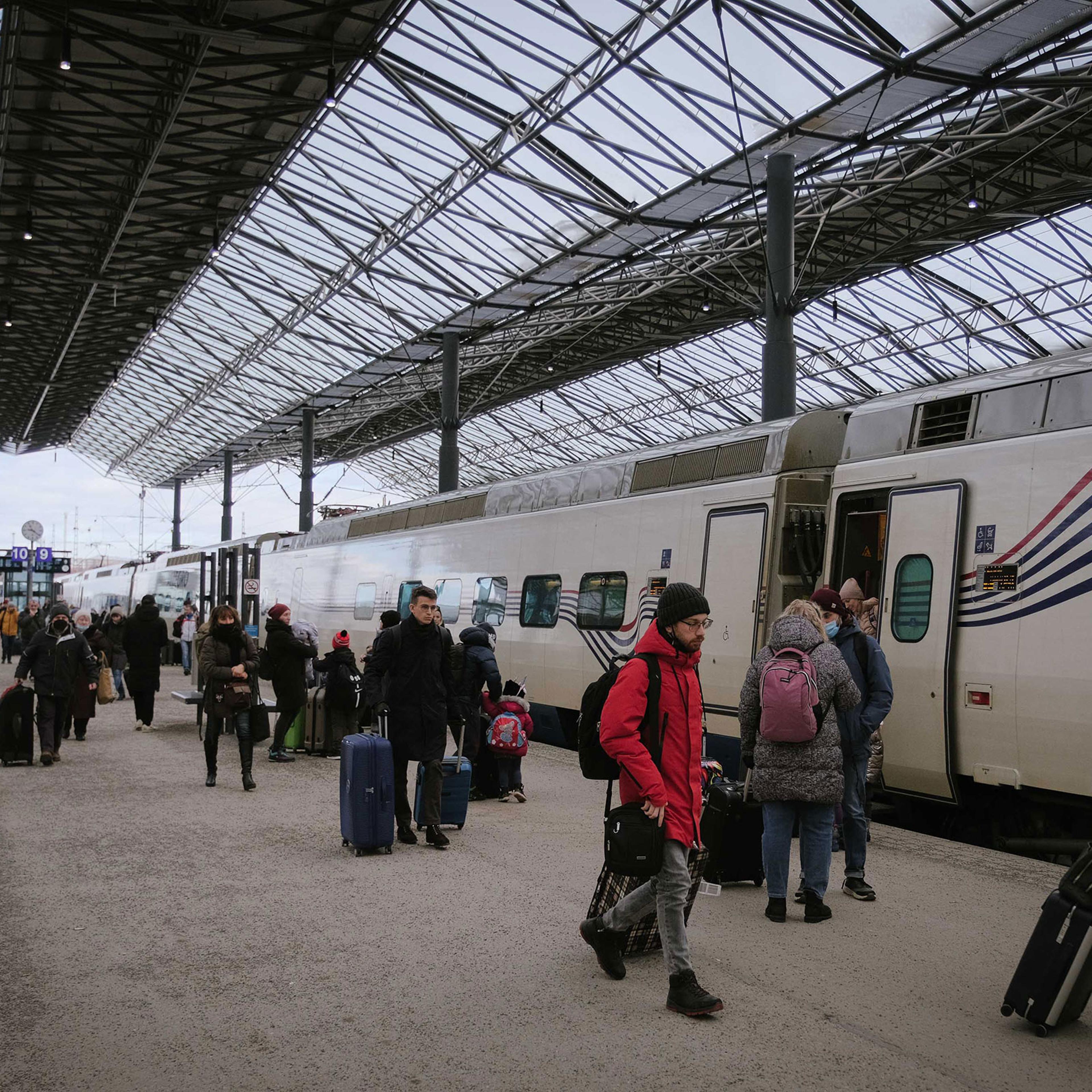 People get off the Allegro train from from St. Petersburg at the central railway station in Helsinki, Finland on March 3, 2022.
