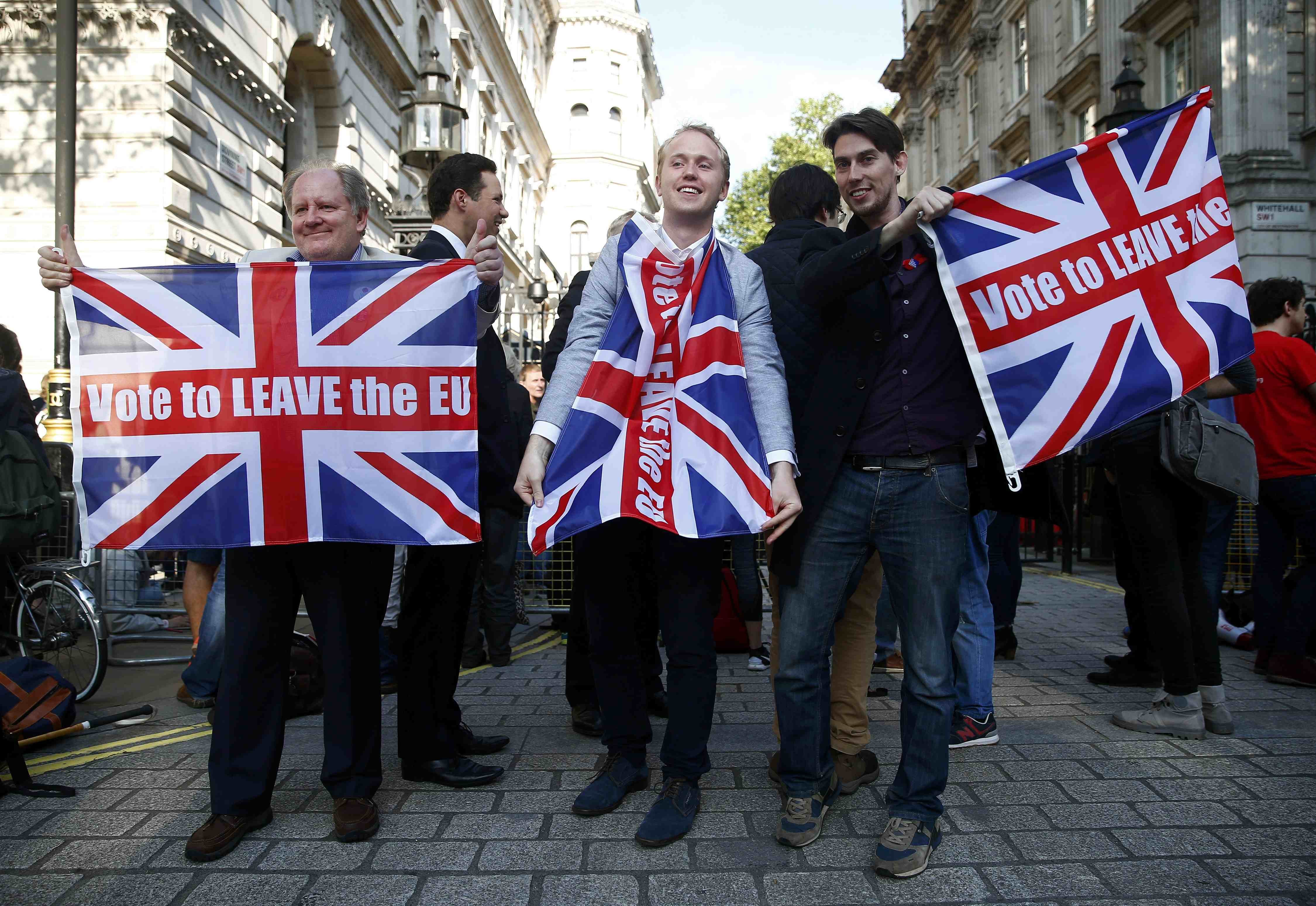 Vote leave supporters wave Union flags, following the result of the EU referendum, outside Downing Street in London on June 24, 2016.