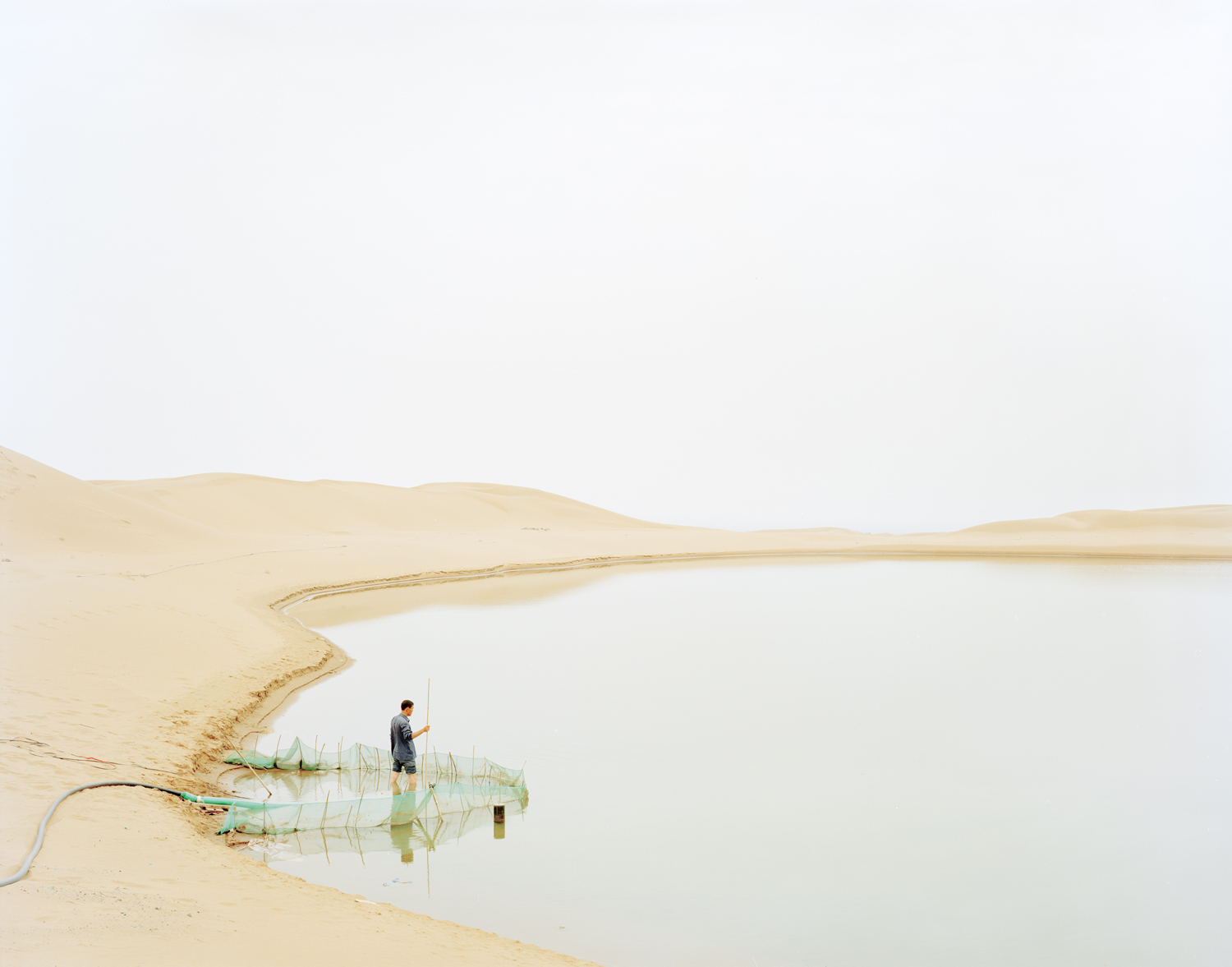 image: A man pumping water from the river, Ningxia province.