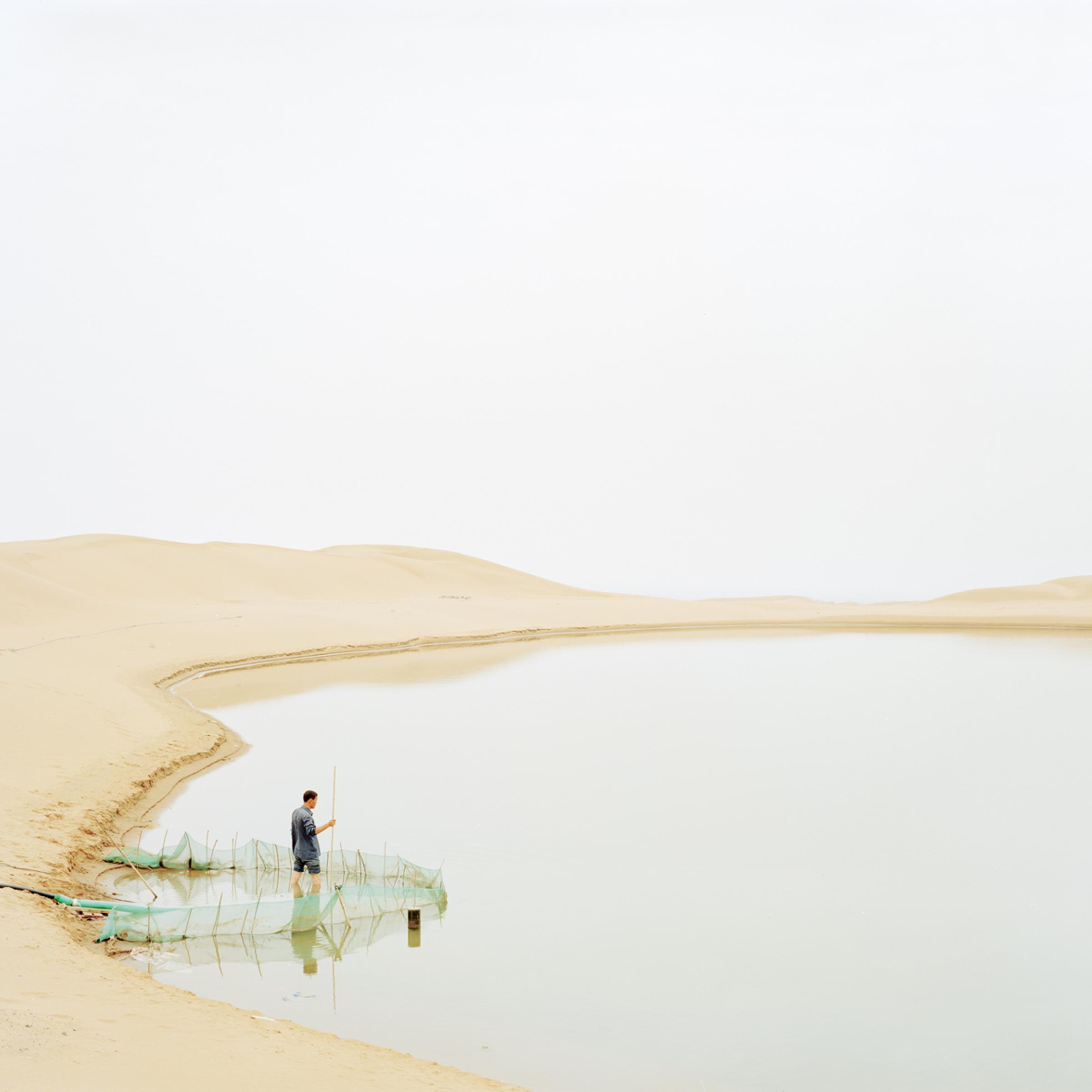 image: A man pumping water from the river, Ningxia province.