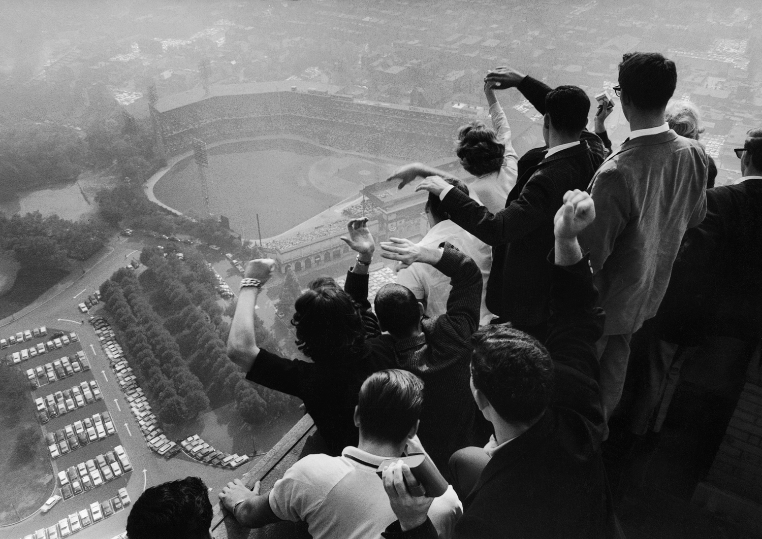 University of Pittsburgh students cheer wildly from atop the Cathedral of Learning as they look down on Forbes Field, where the Pittsburgh Pirates are playing the Yankees in the 7th game of a Series that would enter baseball lore when Bill Mazeroski smac