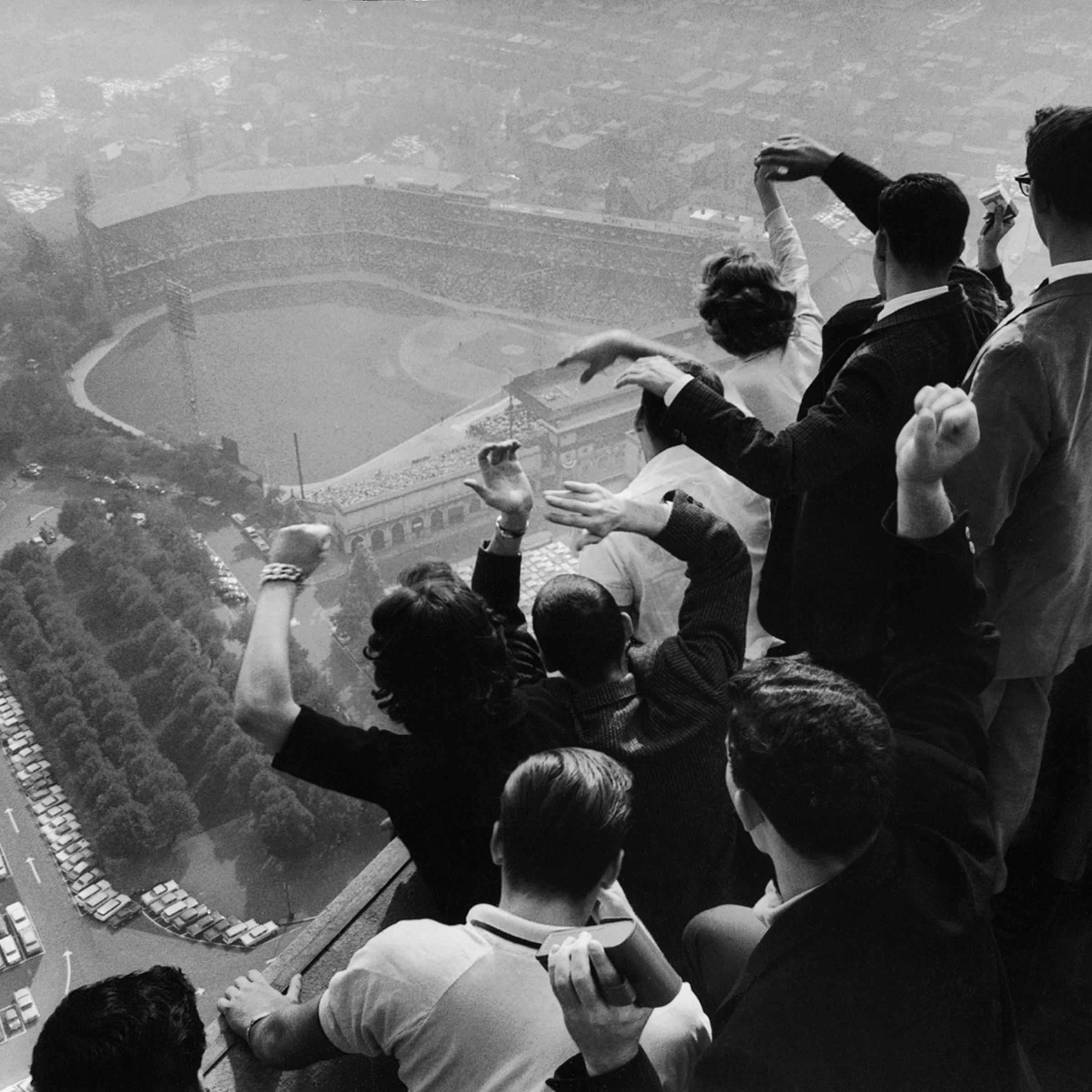 University of Pittsburgh students cheer wildly from atop the Cathedral of Learning as they look down on Forbes Field, where the Pittsburgh Pirates are playing the Yankees in the 7th game of a Series that would enter baseball lore when Bill Mazeroski smac