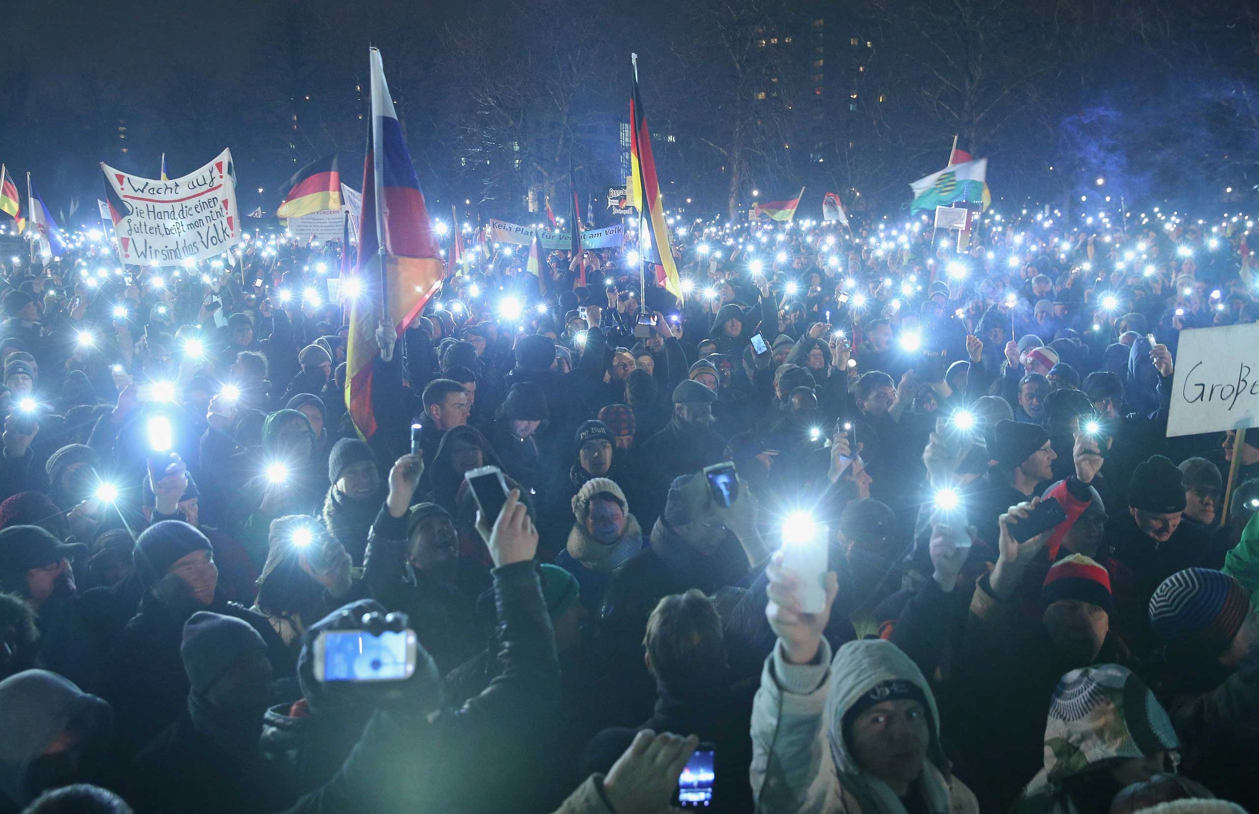 Supporters of the Pegida movement hold up their smartphones at the conclusion of another of their weekly gatherings on Jan. 5, 2015 in Dresden, Germany.