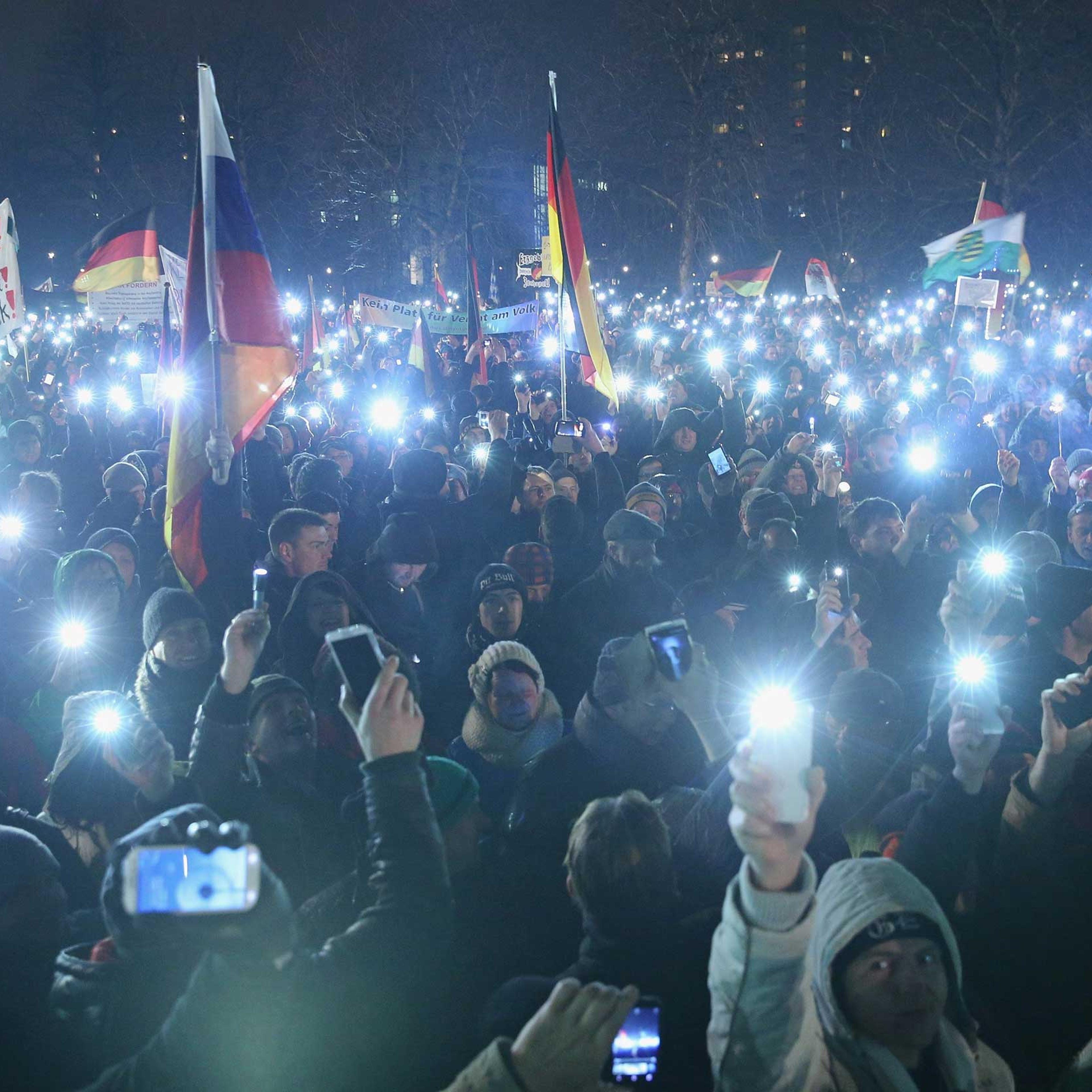 Supporters of the Pegida movement hold up their smartphones at the conclusion of another of their weekly gatherings on Jan. 5, 2015 in Dresden, Germany.