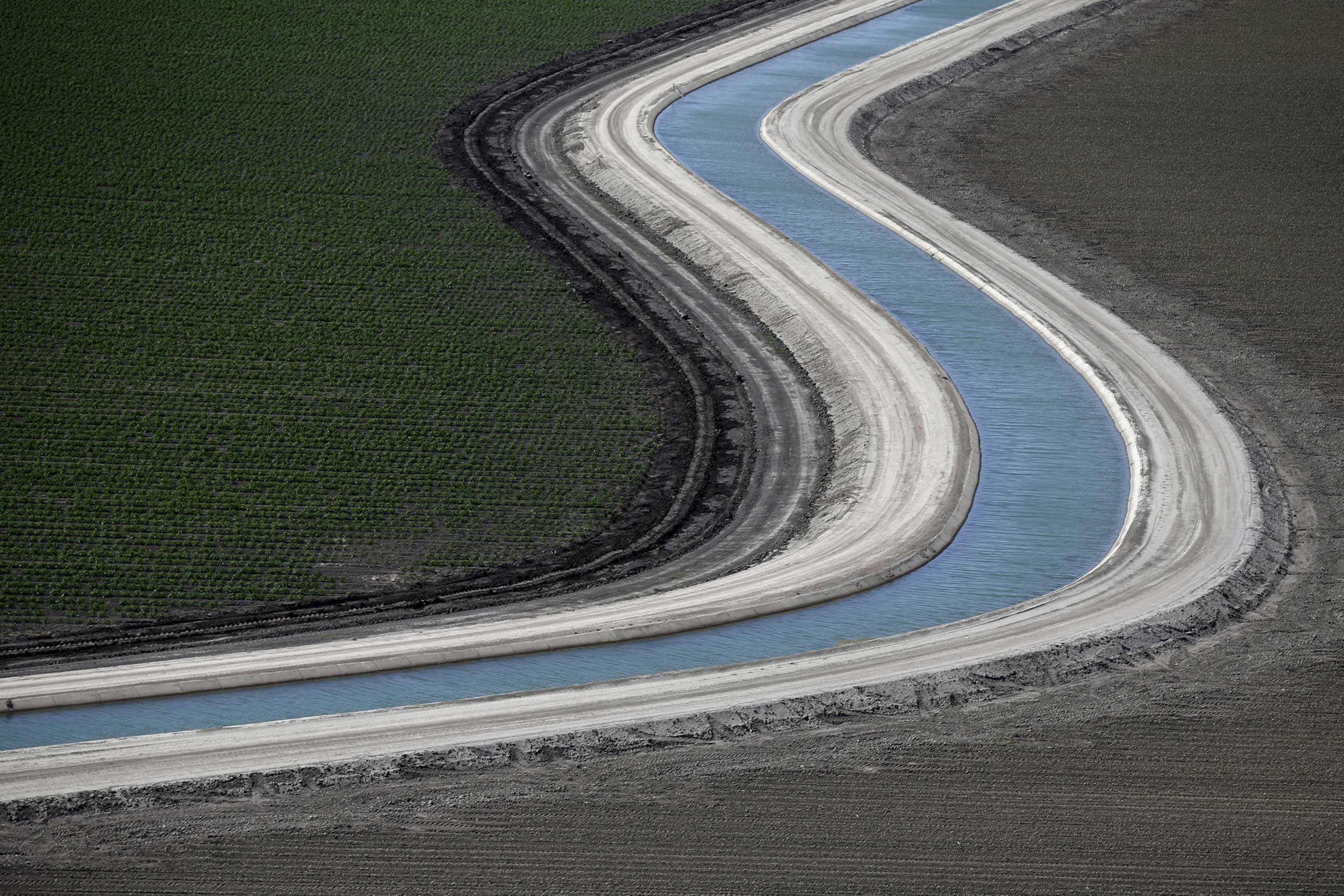 A canal runs through farm fields in Los Banos