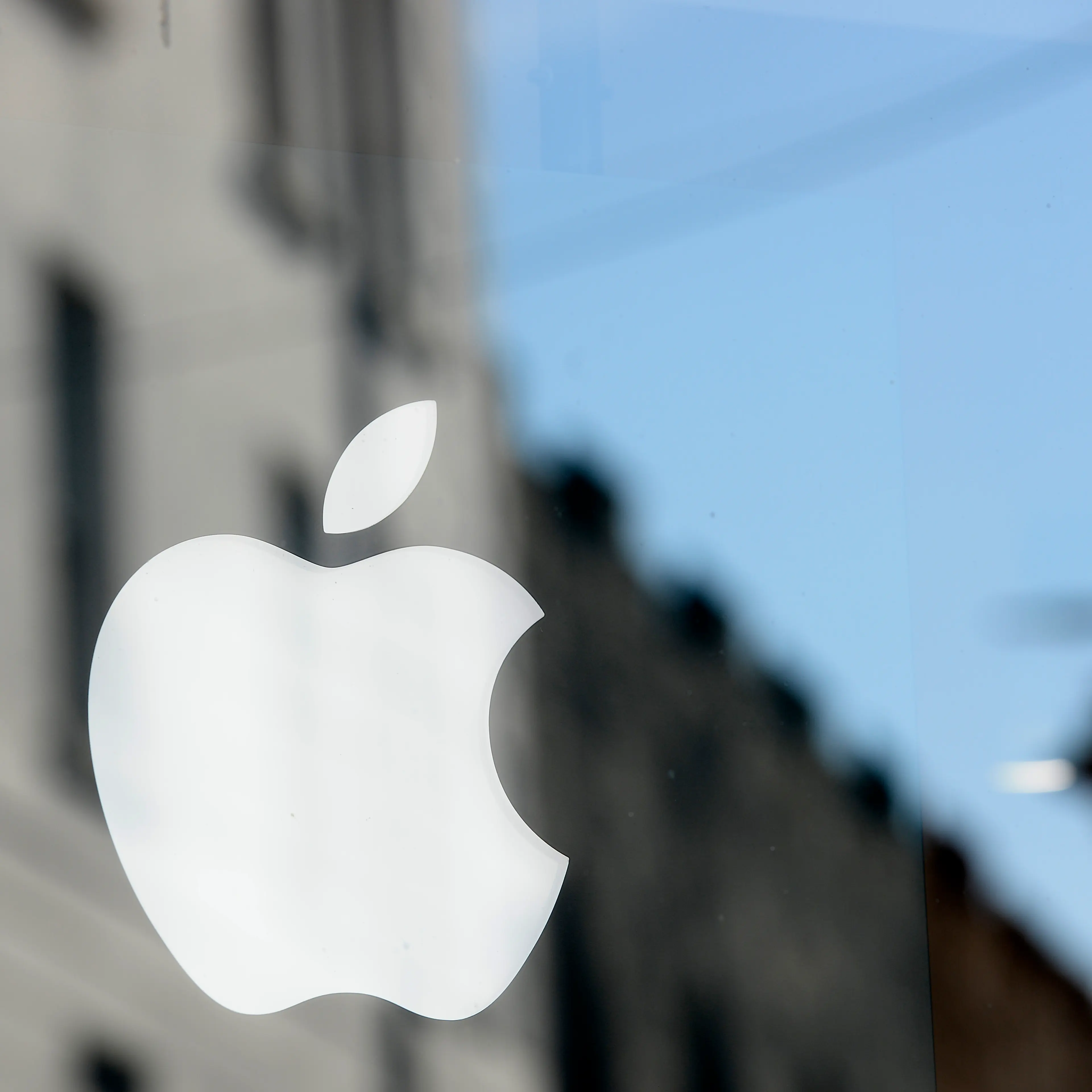 An Apple logo is seen in the window of an authorised apple reseller store in Galway