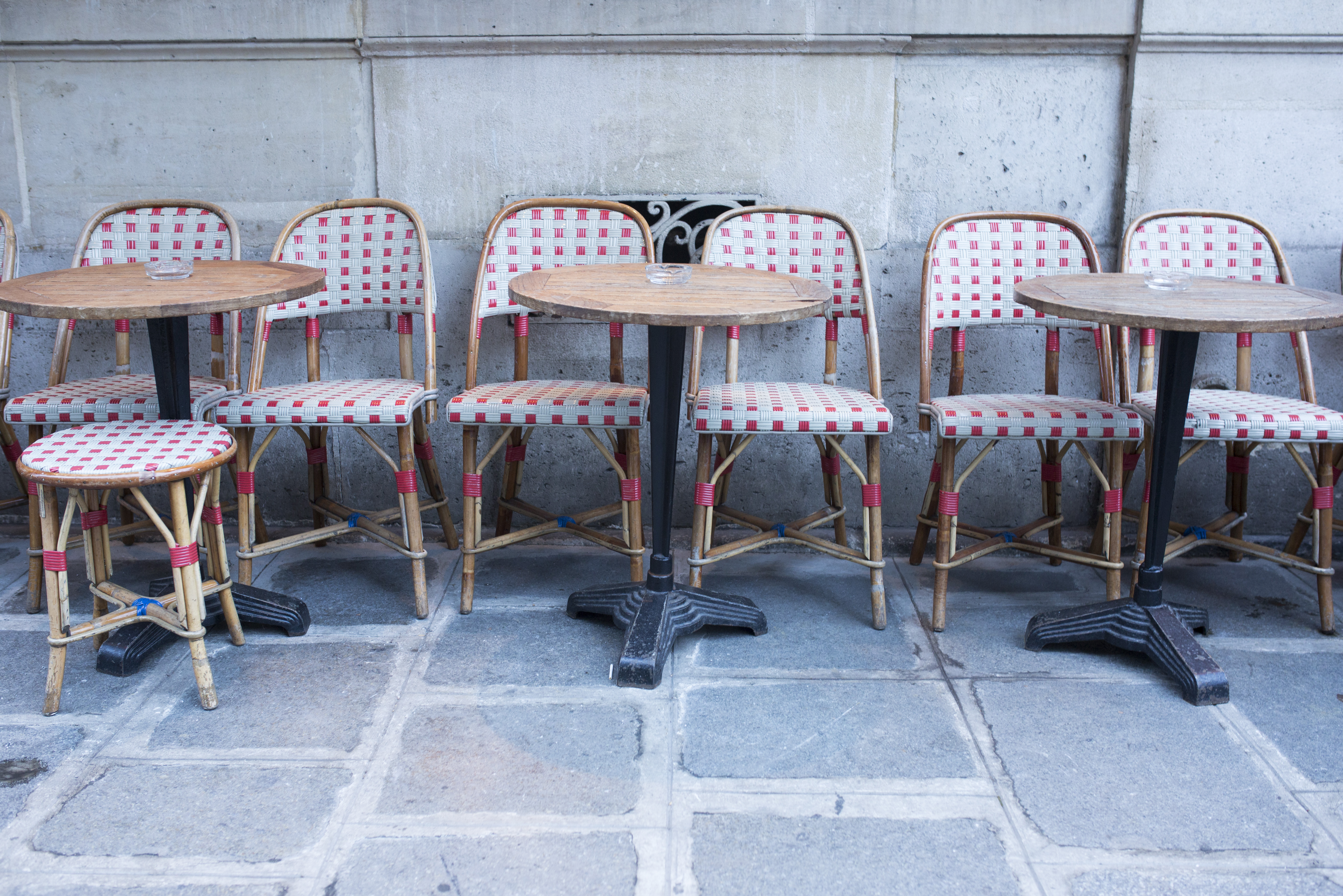 Tables and chairs at empty sidewalk cafe