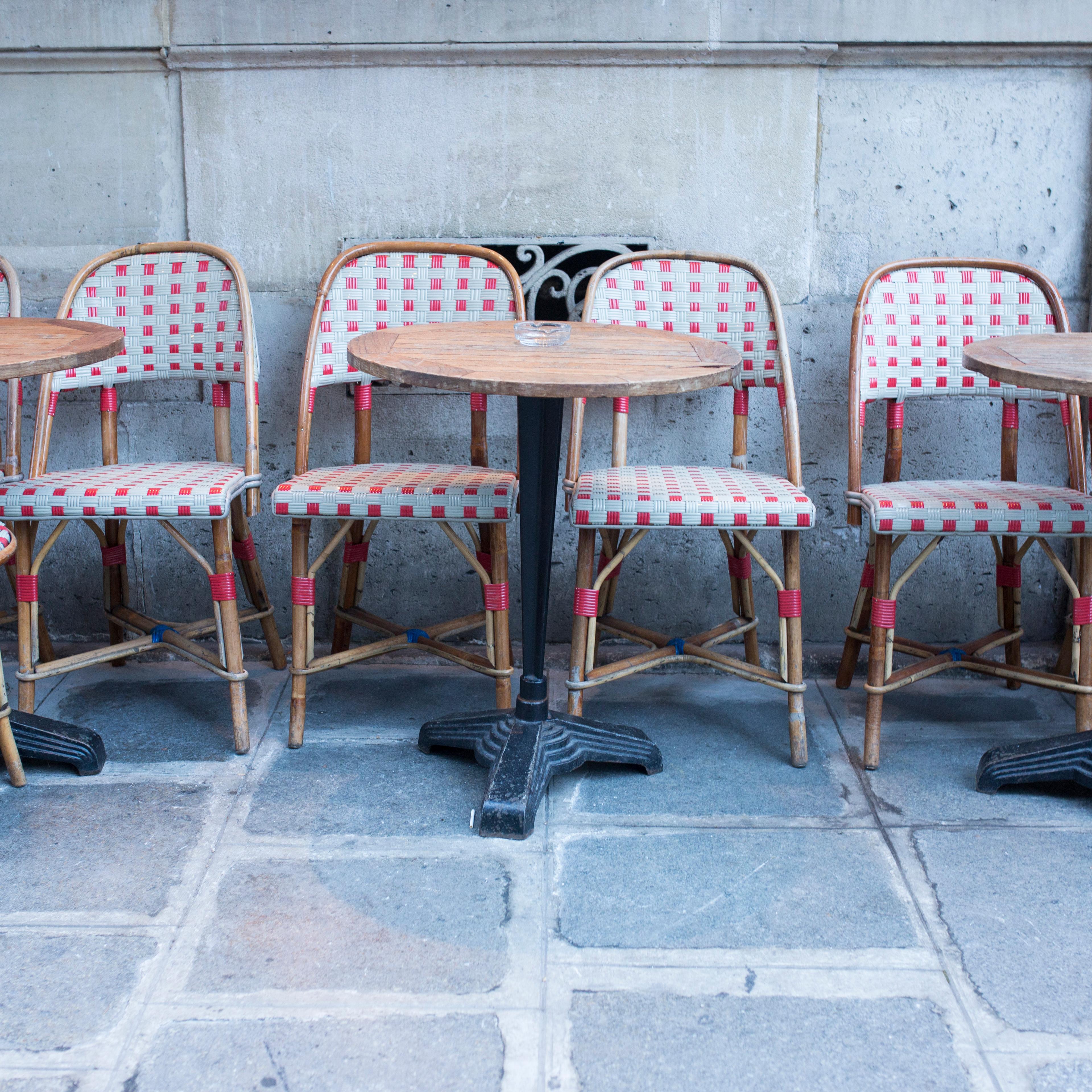 Tables and chairs at empty sidewalk cafe