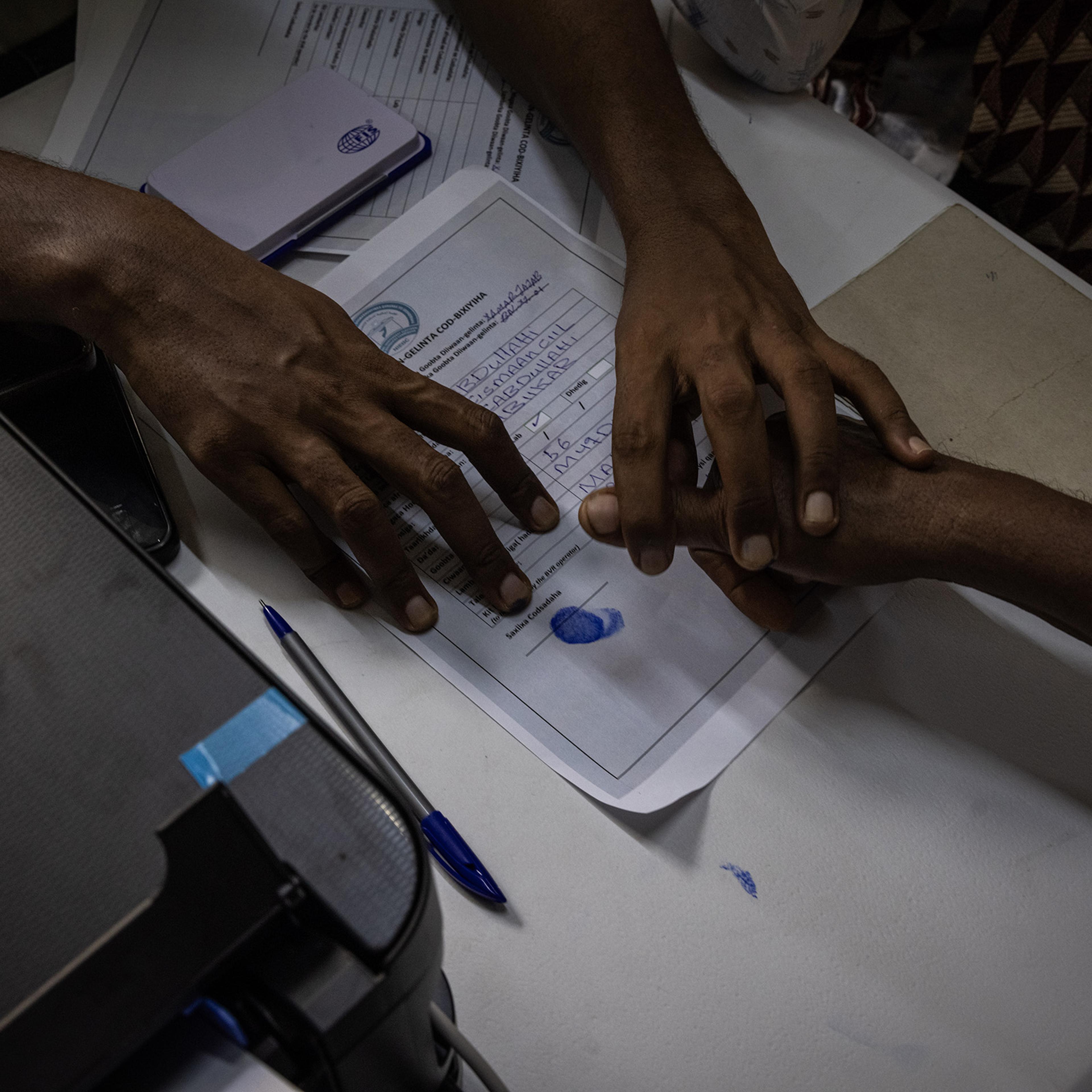 People have their photos, finger prints and details taken as they are registered to vote in a voting registration run by the National Independent Electoral Boundaries Commission in Mogadishu, Somalia.
