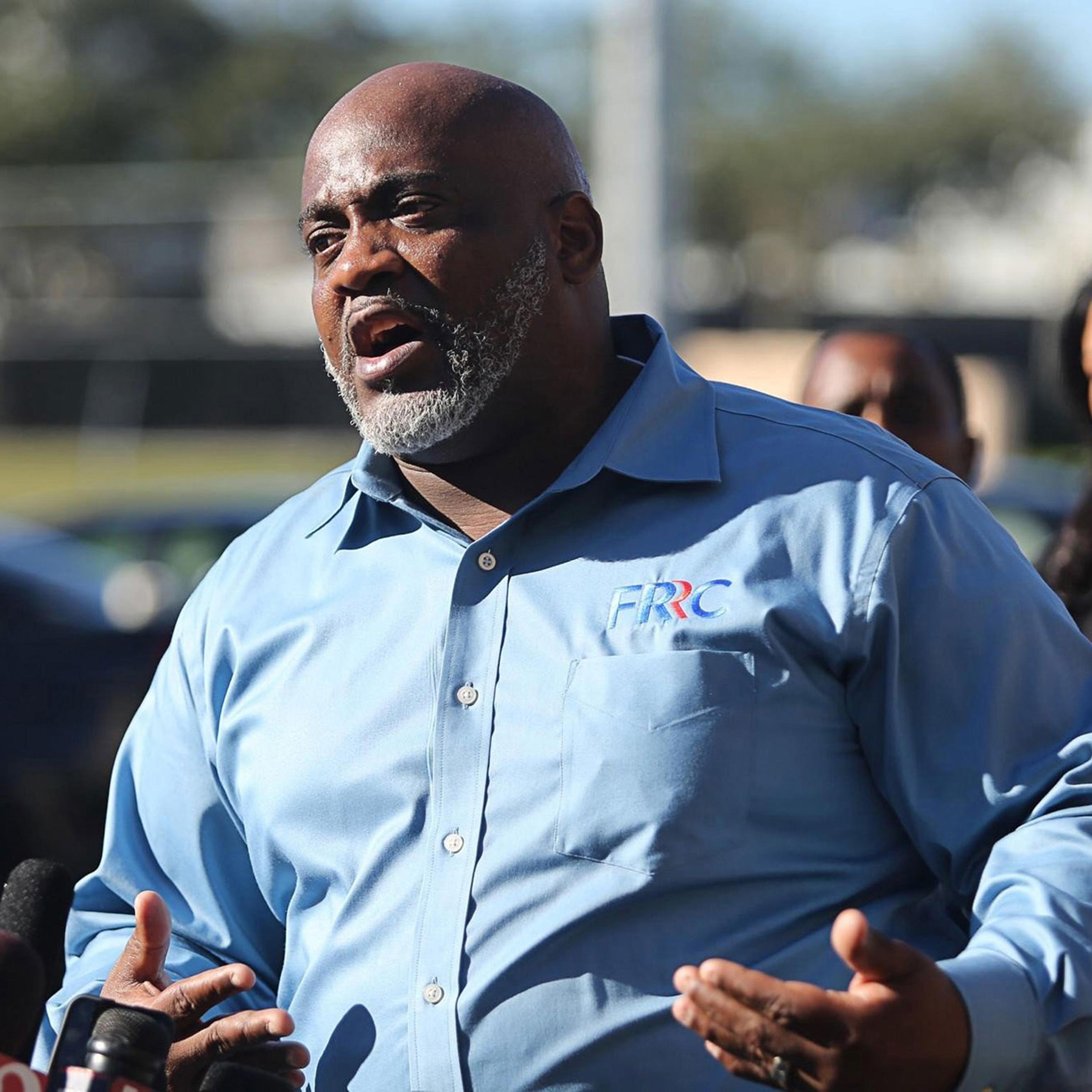 Desmond Meade, president of the Florida Rights Restoration Coalition, holds a news conference in front of the Orange County Supervisor of Elections