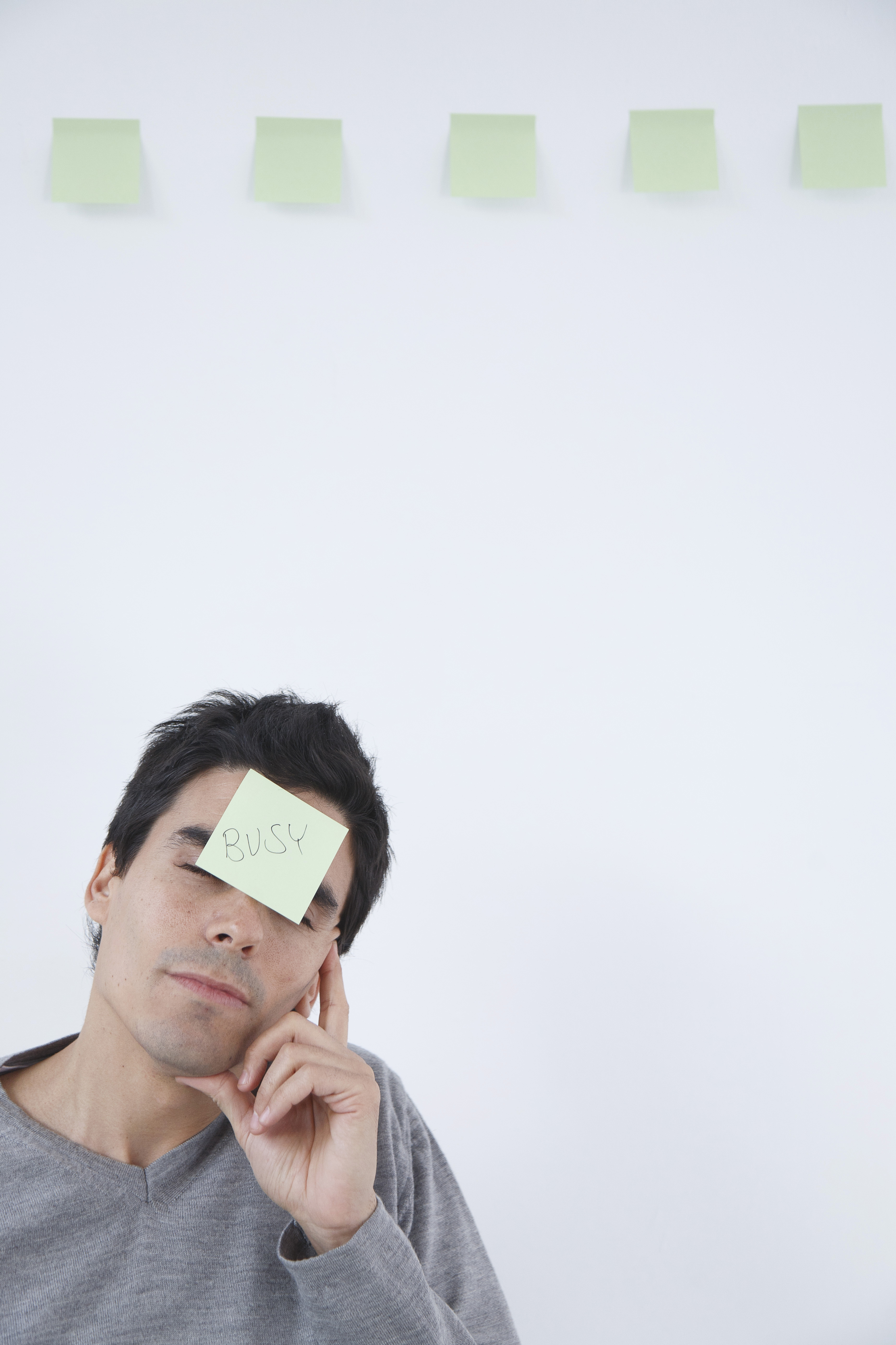 Man with 'busy' post-it note on his head