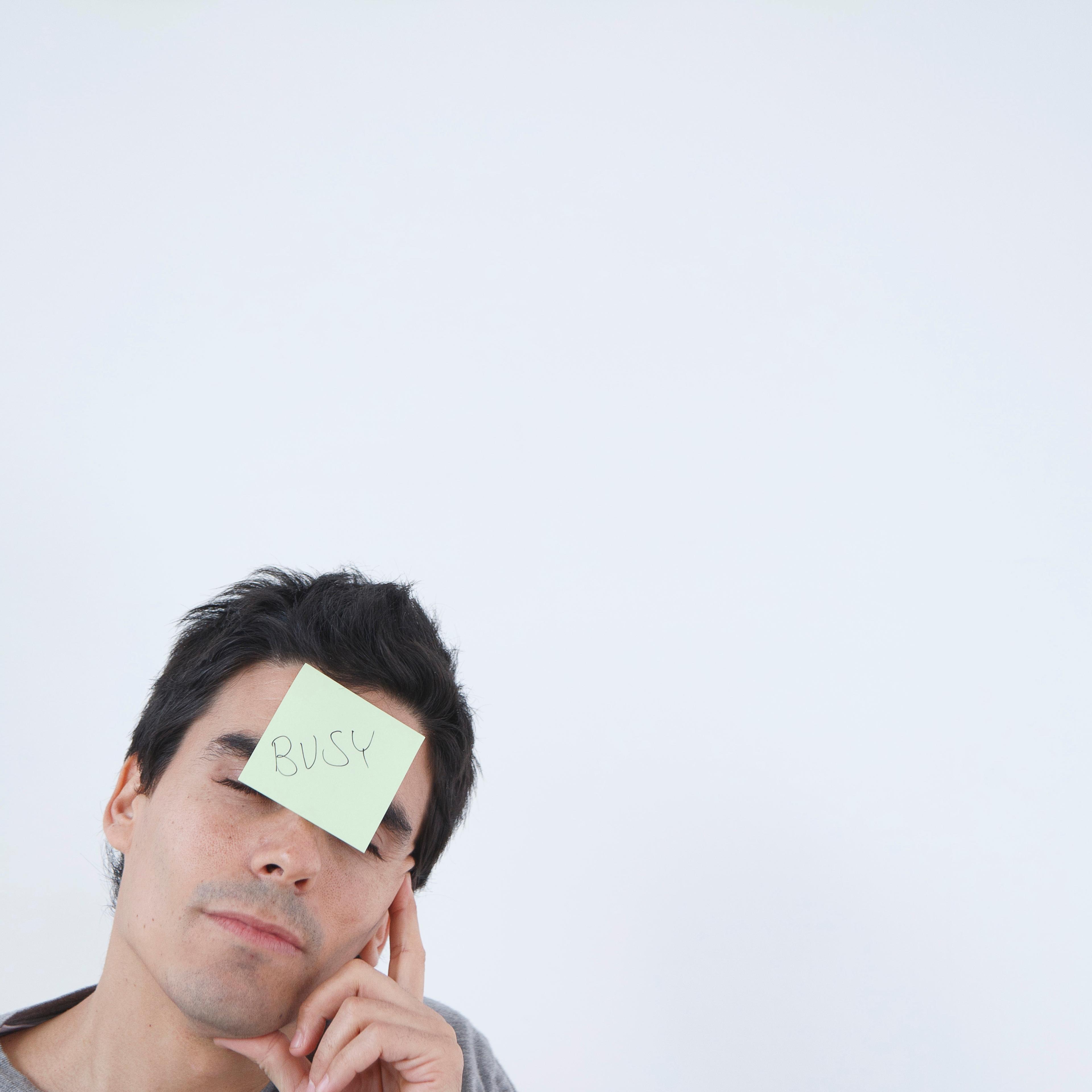 Man with 'busy' post-it note on his head