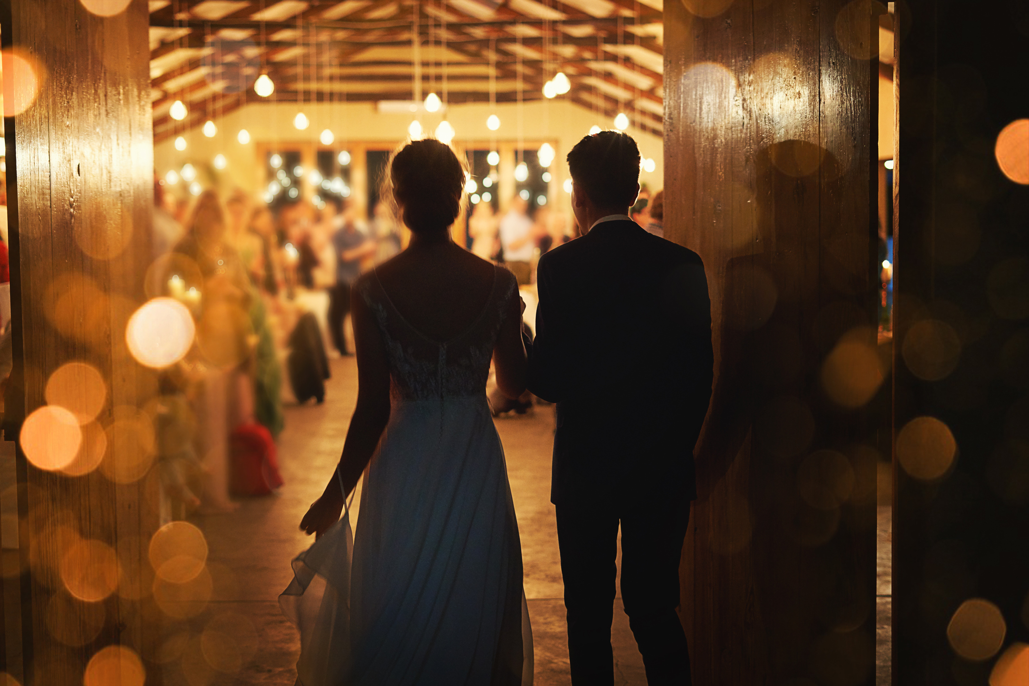 A newlywed couple entering their reception.