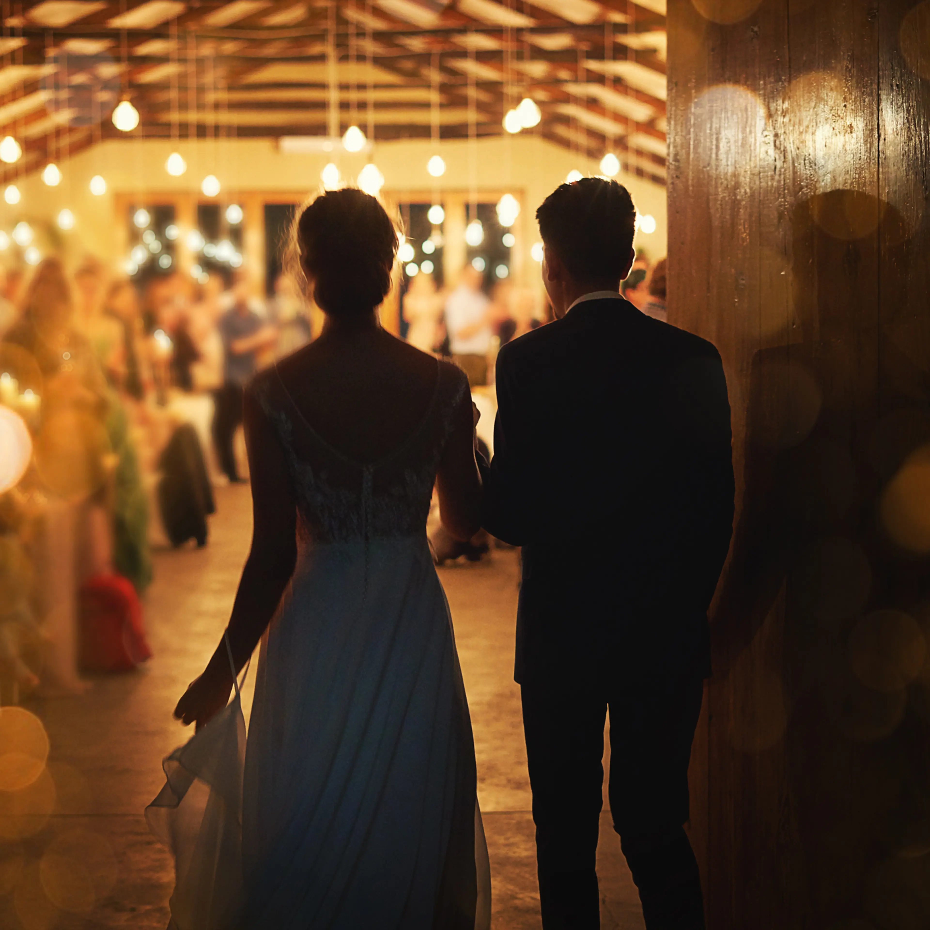 A newlywed couple entering their reception.