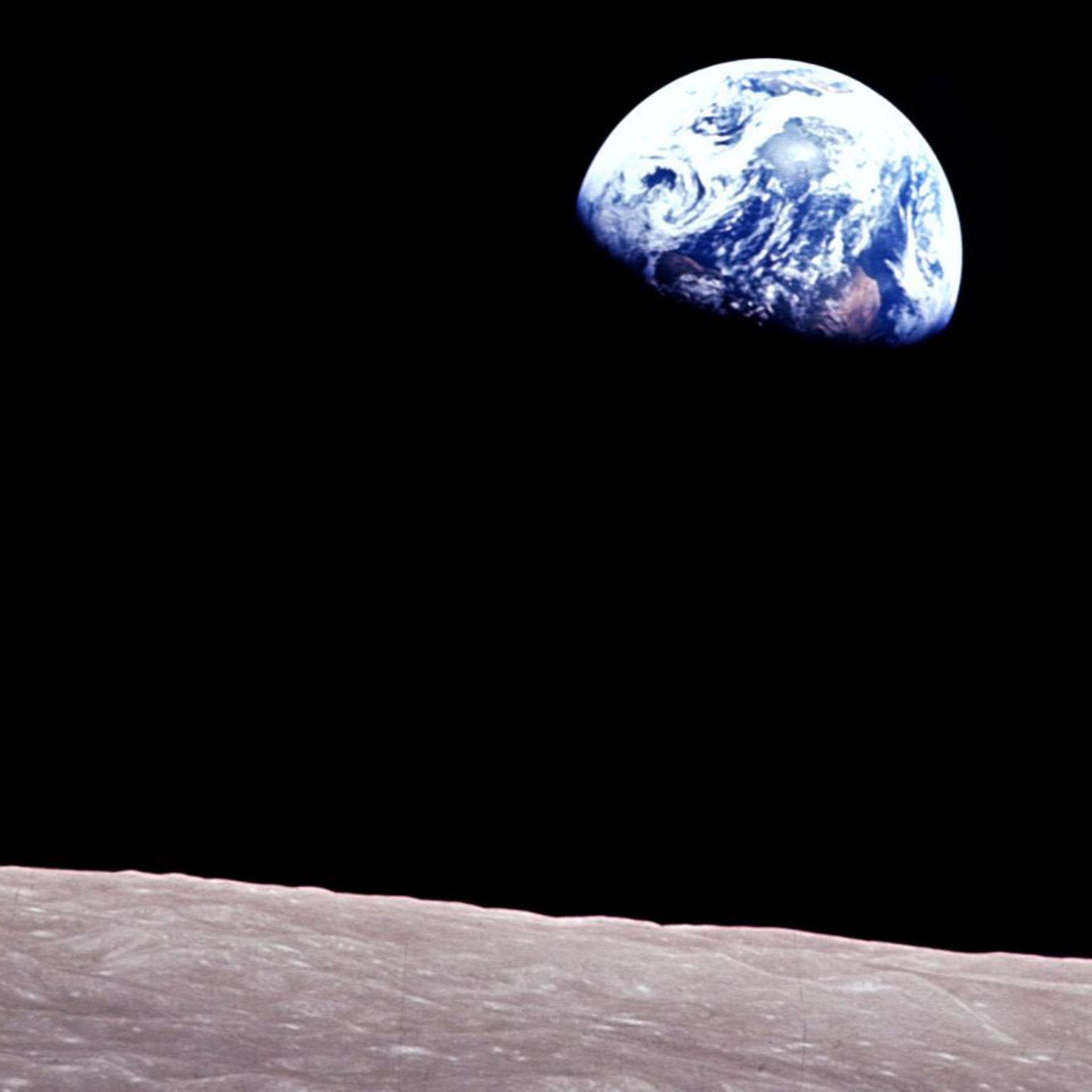 Taken aboard Apollo 8 by Bill Anders, this iconic picture shows Earth peeking out from beyond the lunar surface as the first crewed spacecraft circumnavigated the moon, with astronauts Anders, Frank Borman, and Jim Lovell aboard.