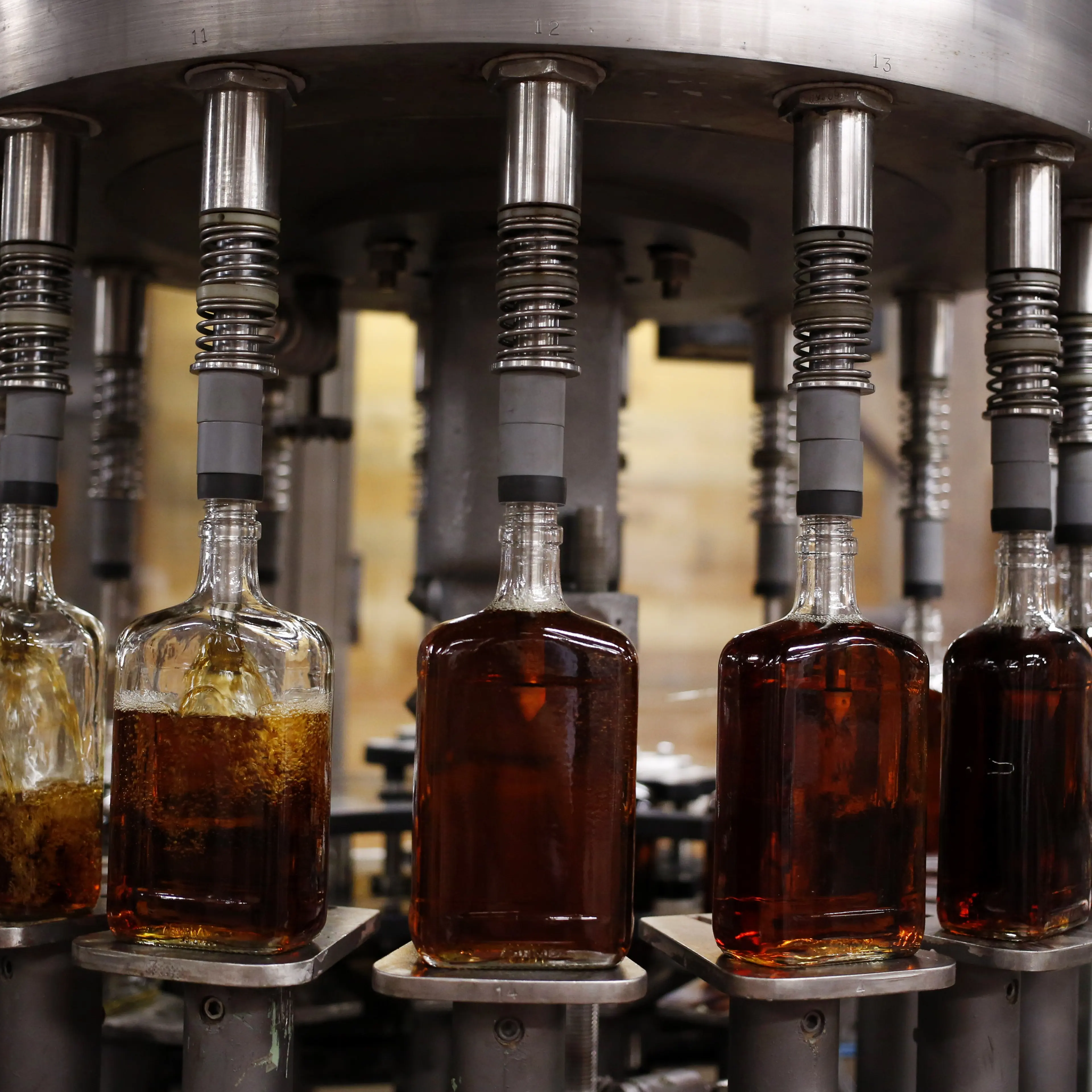 Bottles of single barrel bourbon are filled on a bottling line