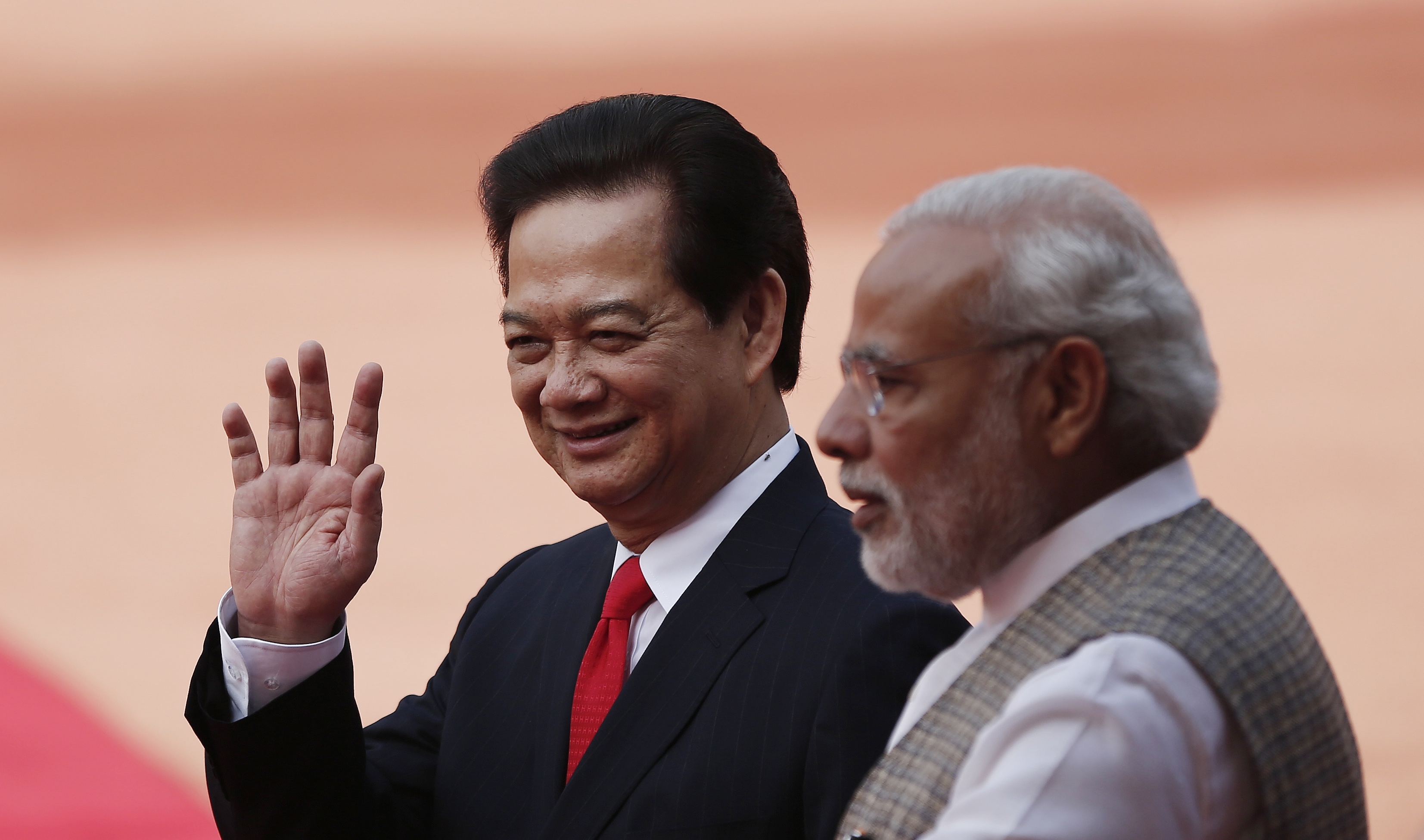 Vietnam's PM Dung waves next to his Indian counterpart Modi at the forecourt of India's presidential palace Rashtrapati Bhavan in New Delhi