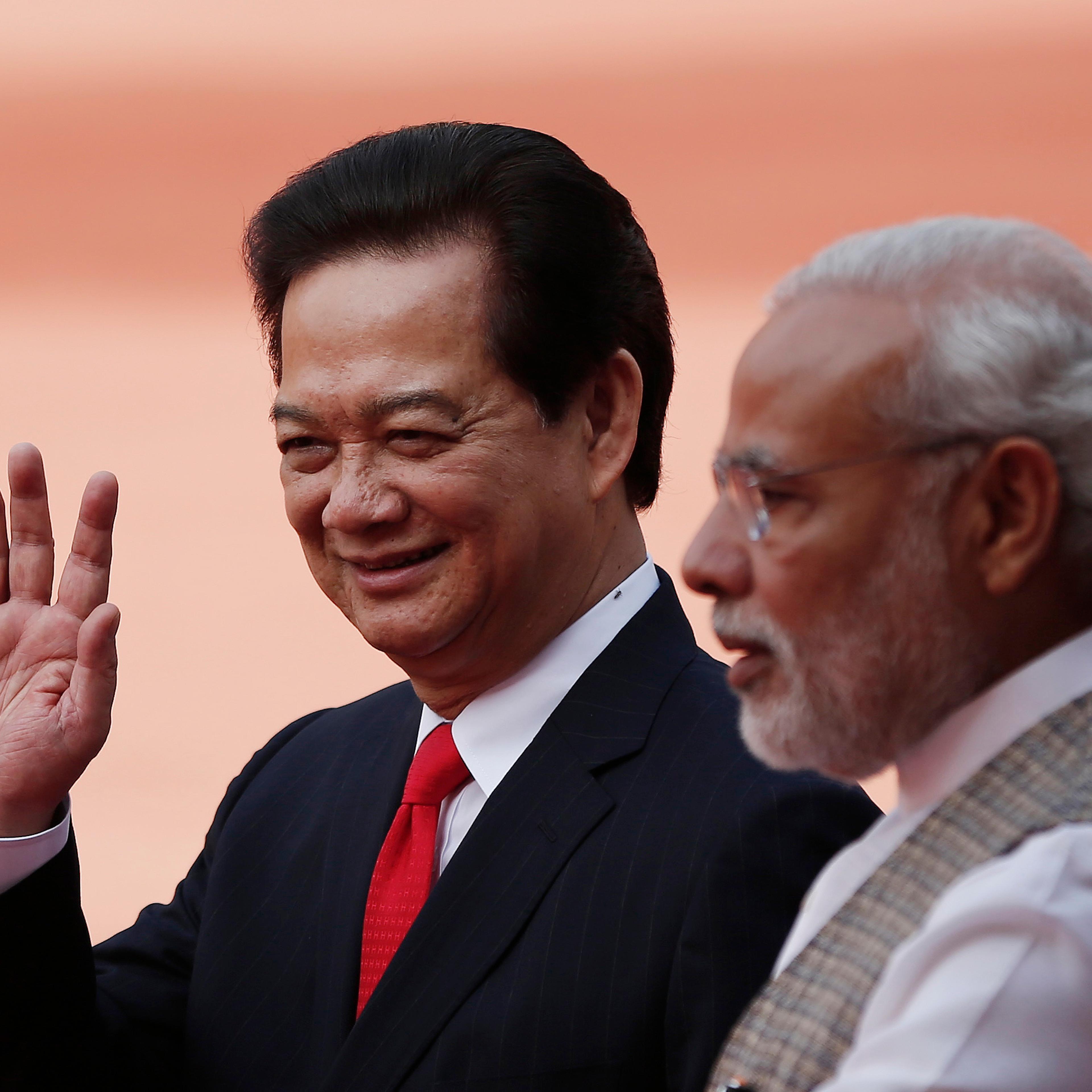 Vietnam's PM Dung waves next to his Indian counterpart Modi at the forecourt of India's presidential palace Rashtrapati Bhavan in New Delhi