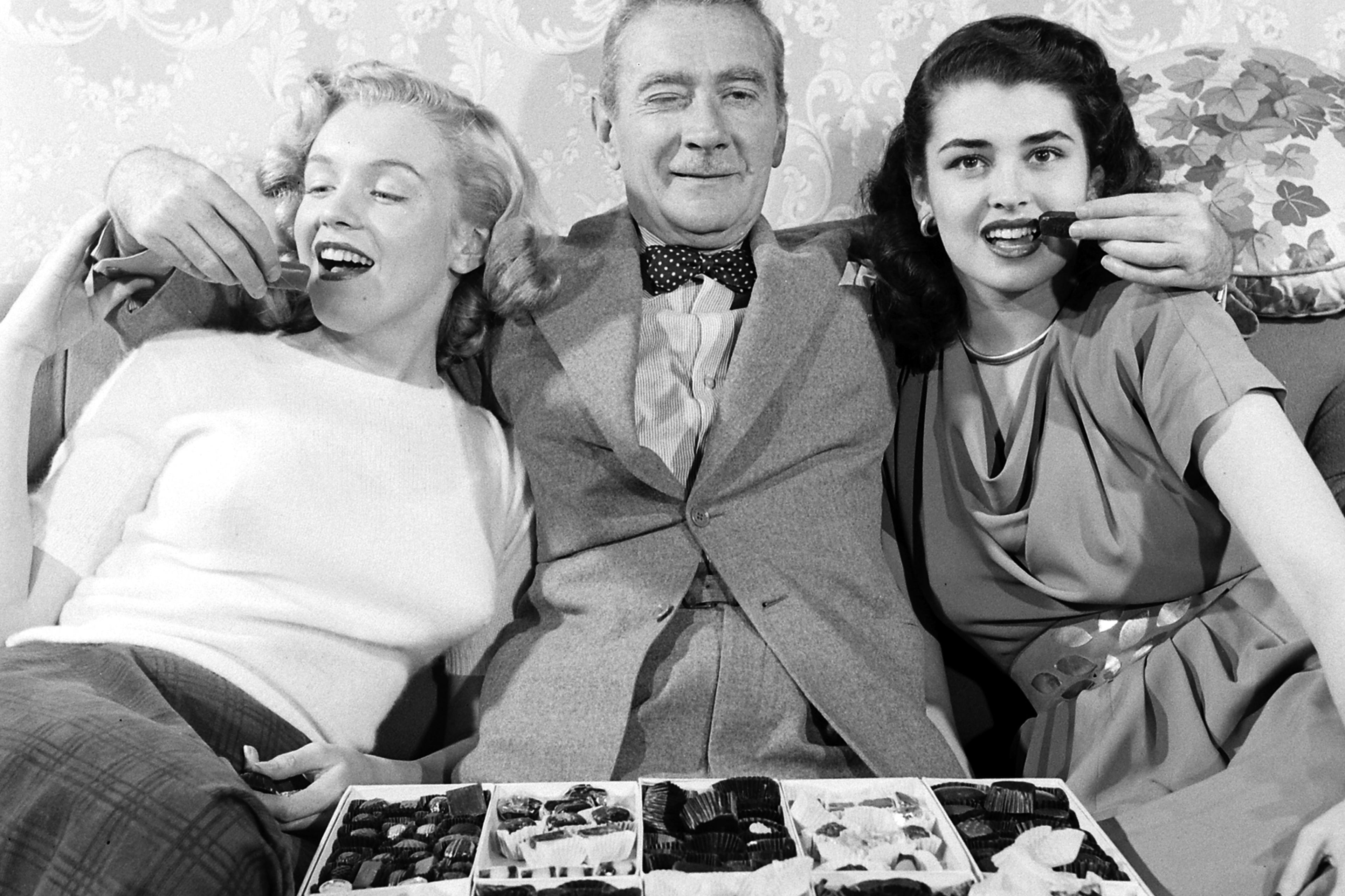 Then-unknown actress Marilyn Monroe with Clifton Webb and Laurette Luez on the set of a 1948 comedy, "Sitting Pretty."