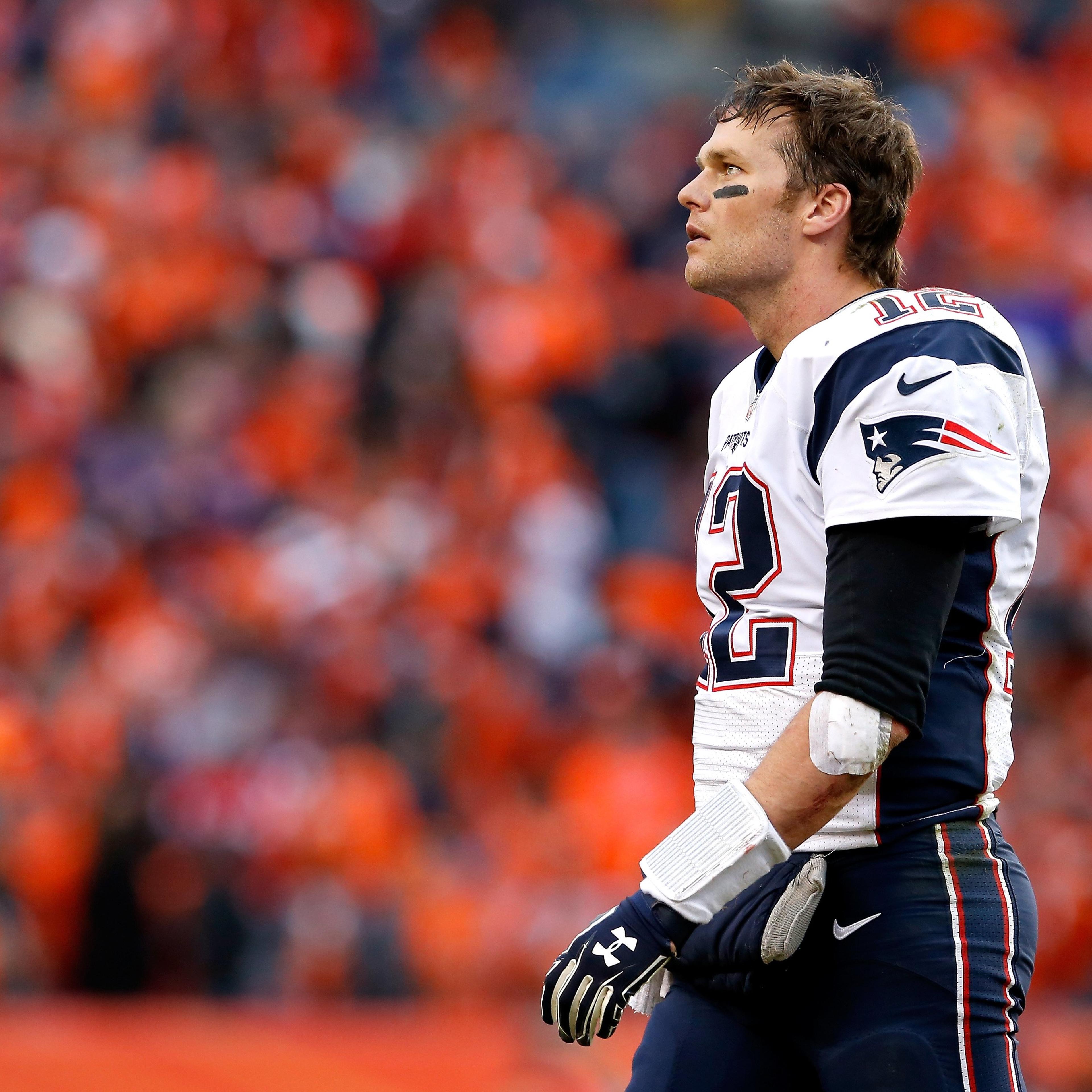 Tom Brady #12 of the New England Patriots walks off the field in the fourth quarter against the Denver Broncos in the AFC Championship game at Sports Authority Field at Mile High in Denver on Jan. 24, 2016.